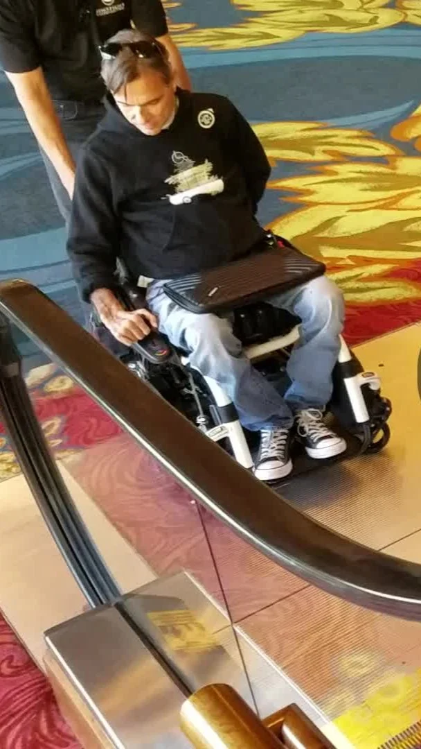A woman in a wheelchair using a boarding ramp at an airport.