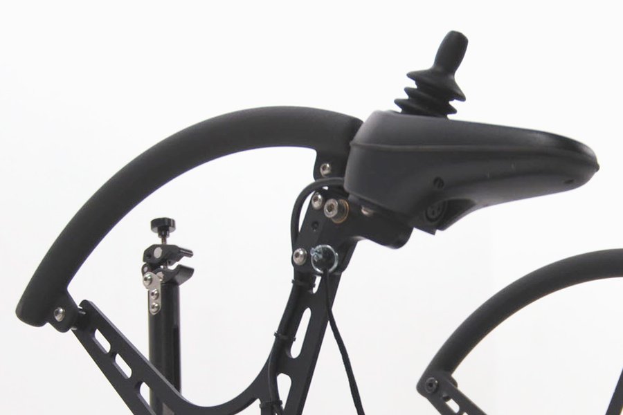 Close-up of a black bicycle handlebar and seat area with visible suspension components and cables against a white background.