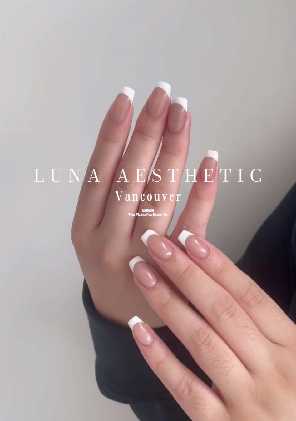 Close-up of a person's hand with French manicure nails, against a plain background, with text overlay reading "LUNA AESTHETIC Vancouver" and some smaller text.