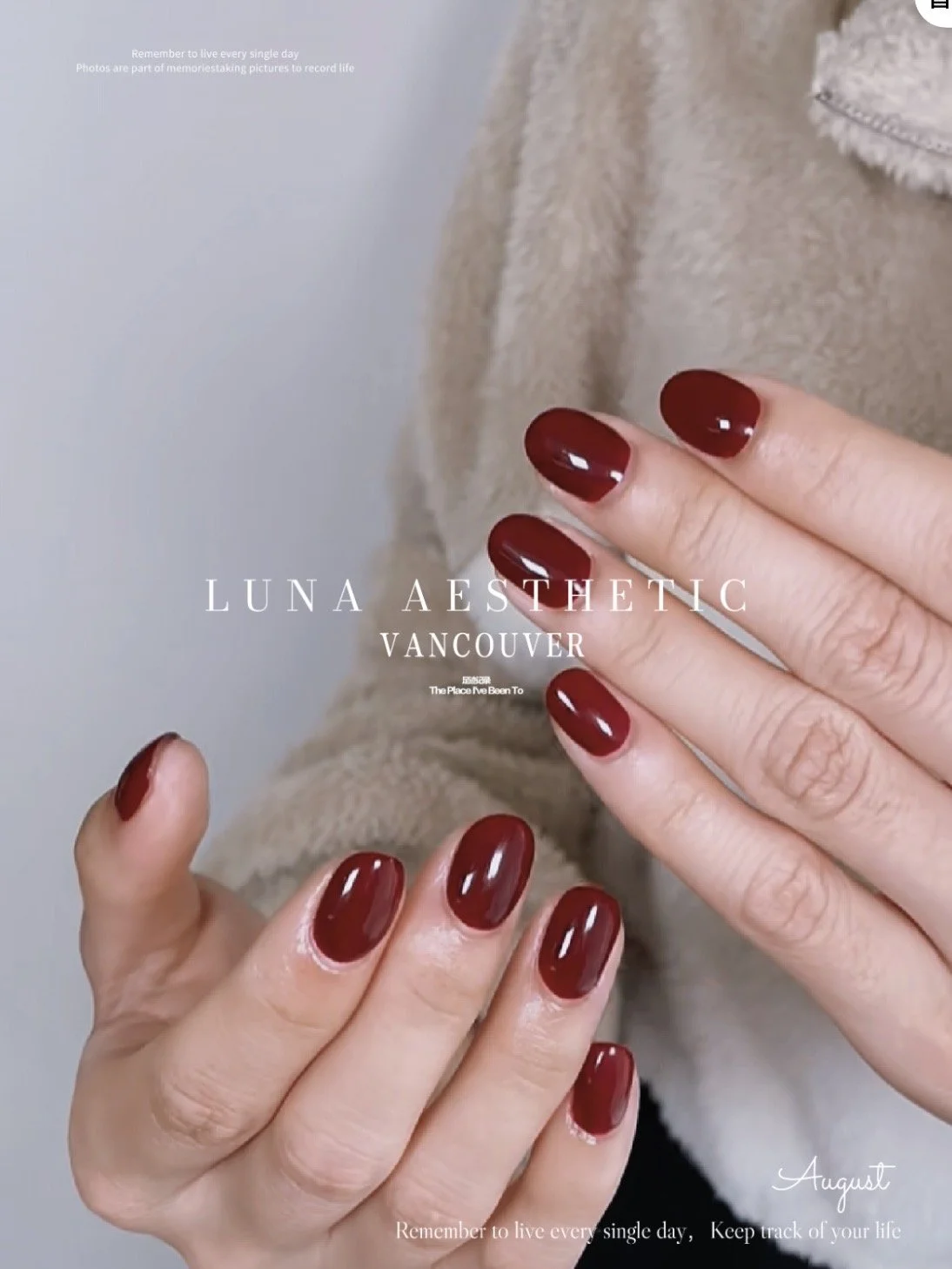 Close-up of hands with manicured nails painted in deep red color, held against a beige fuzzy coat. Overlay text says 'LUNA AESTHETIC VANCOUVER' and other motivational messages.