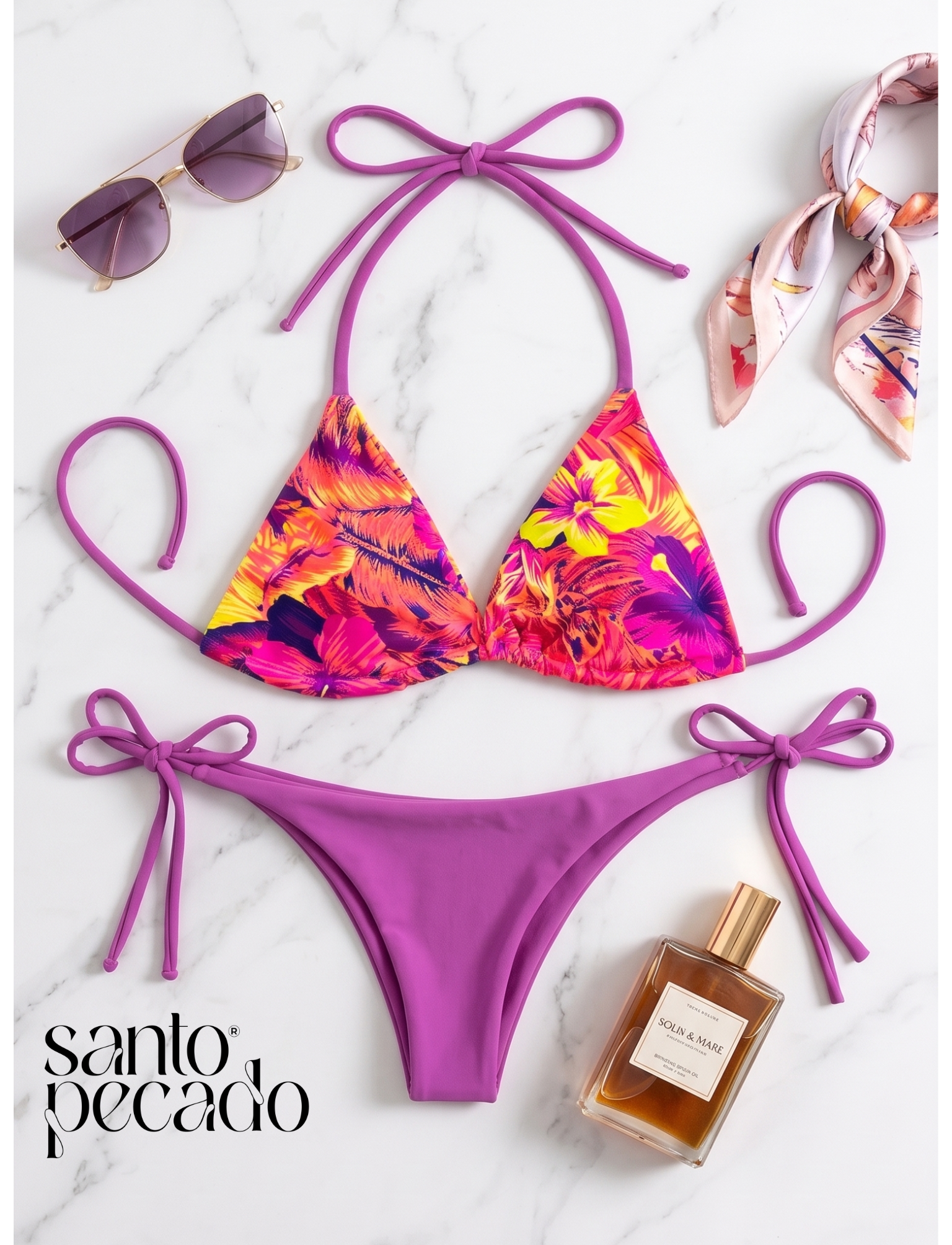 Colorful bikini with purple trim, pink sunglasses with purple lenses, a silk scarf with a floral pattern, and a bottle of Solin & Mare perfume on a white marble surface.
