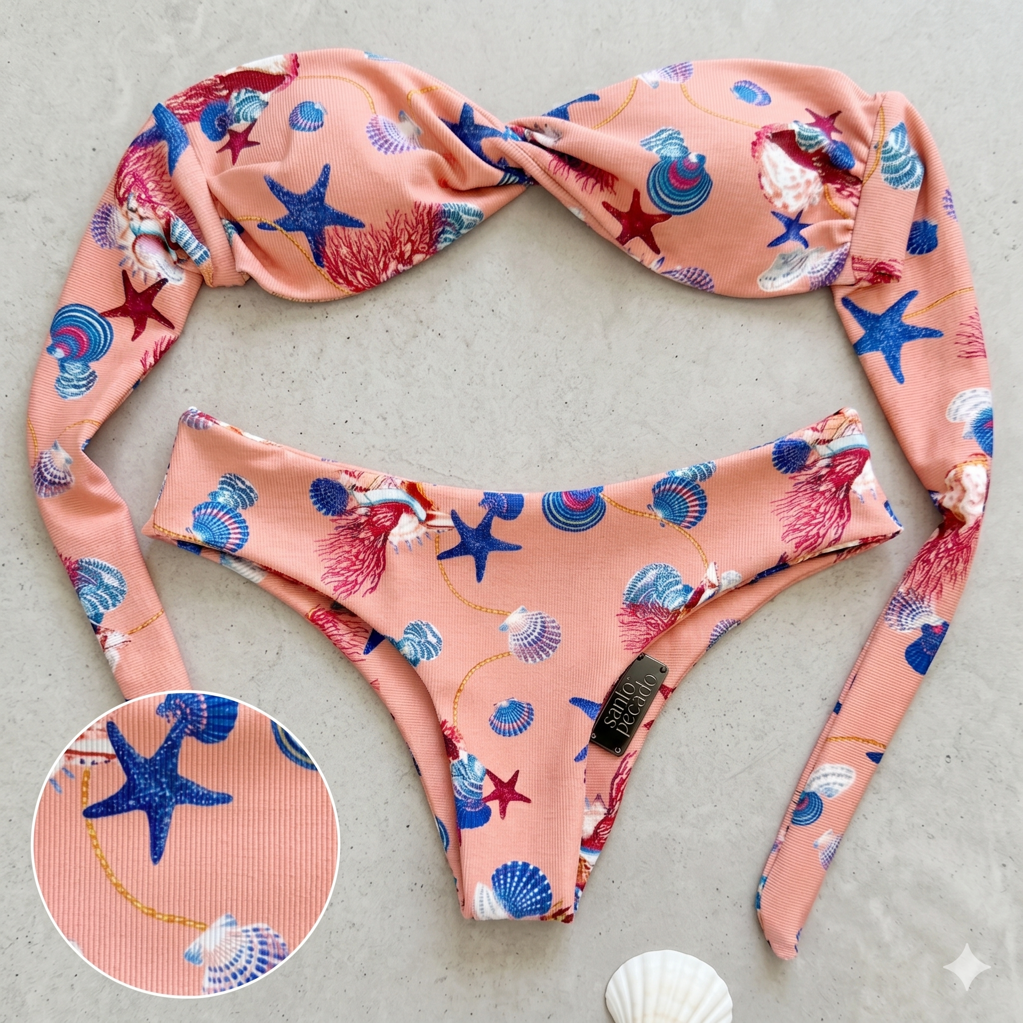 Pink fabric headband with a sea animal print featuring starfish, seashells, and seaweed, laid on a white surface.