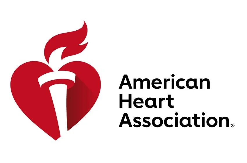 Logo of the American Heart Association featuring a red heart with a white torch and flame, alongside black text.
