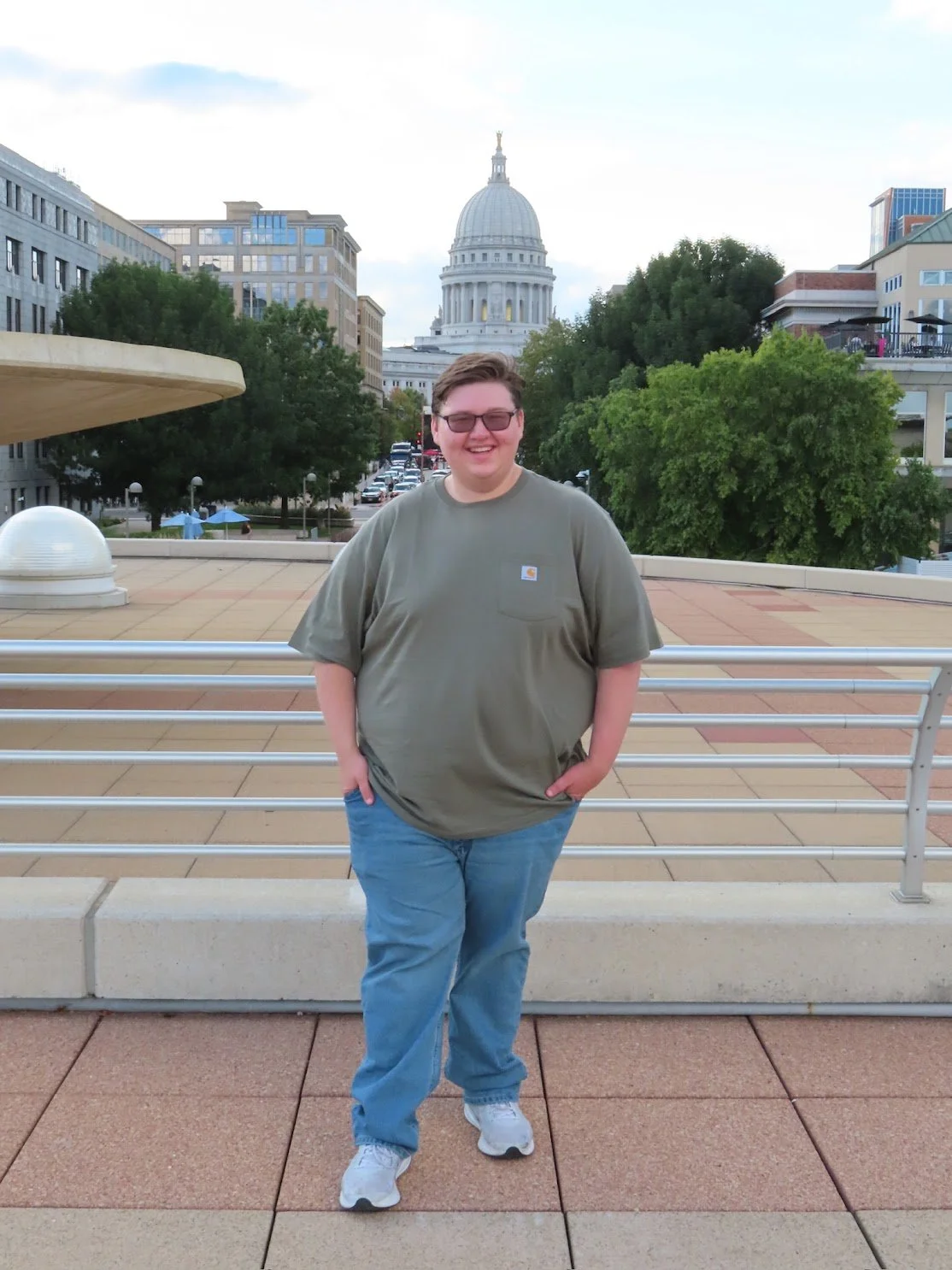 A traveler in front of the capitol building in Madison, WI.