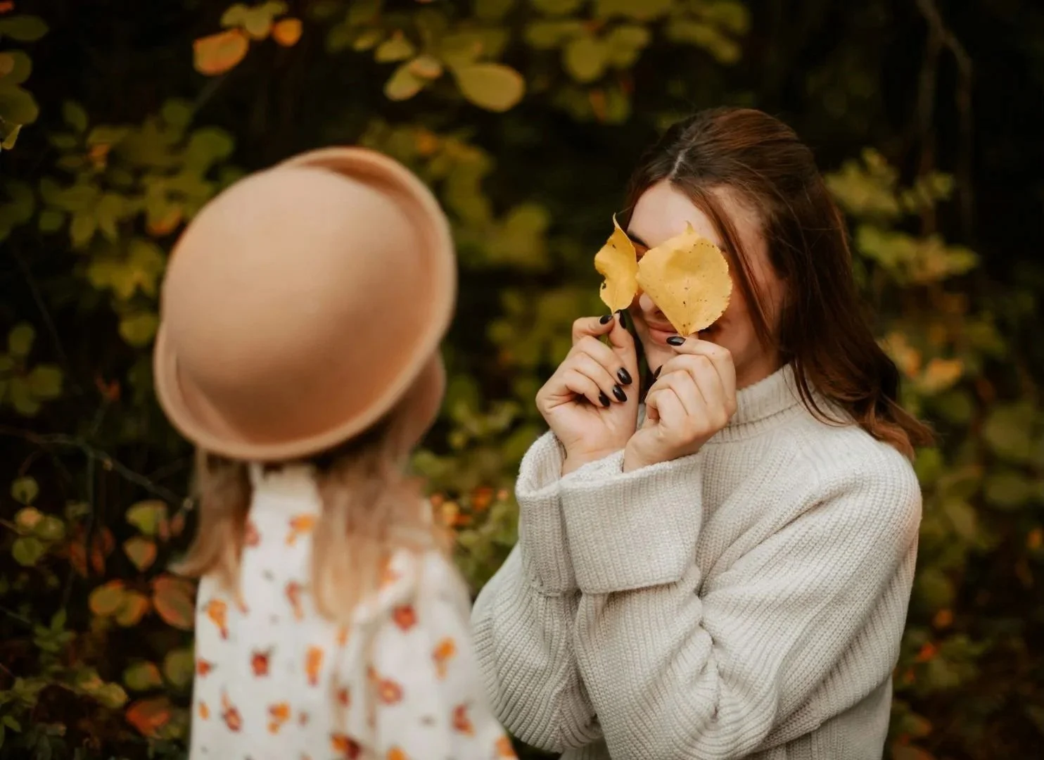 A mother and young daughter playing together, sharing a joyful and connected moment.