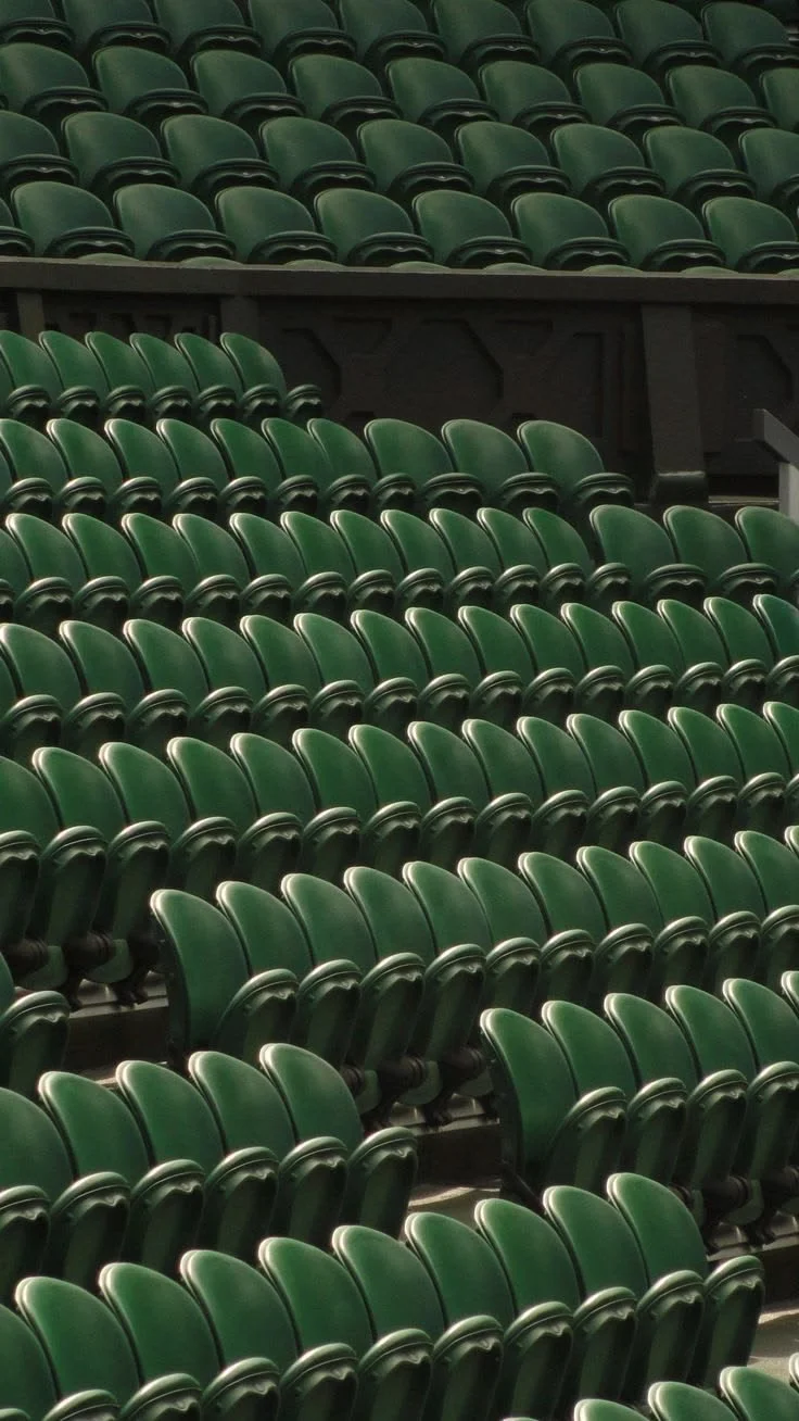 Empty green stadium seats.