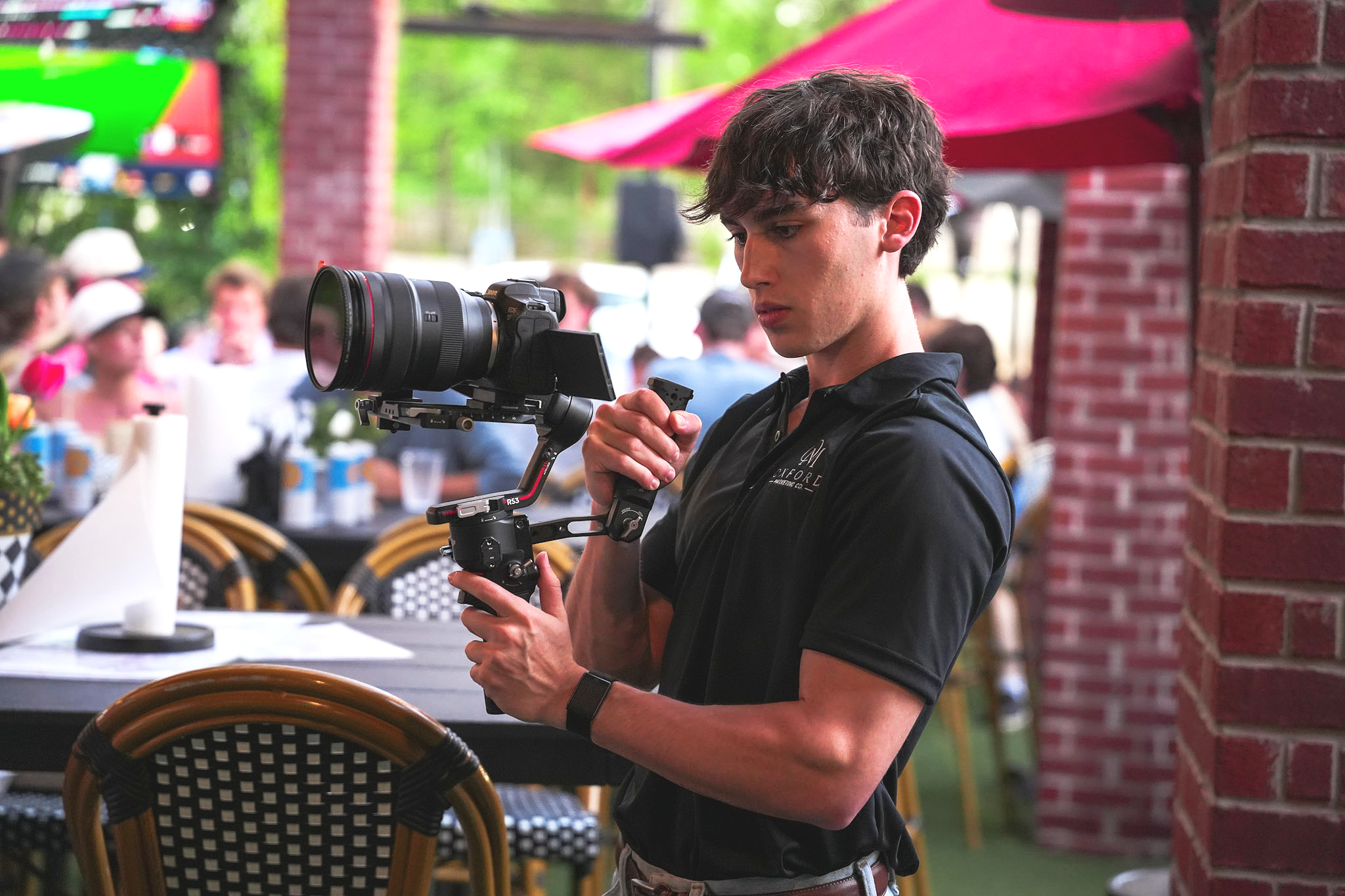 Oxford Marketing Co. photographer Evan Farrell taking photographs at The Velvet Ditch Seafood & Sports Bar.