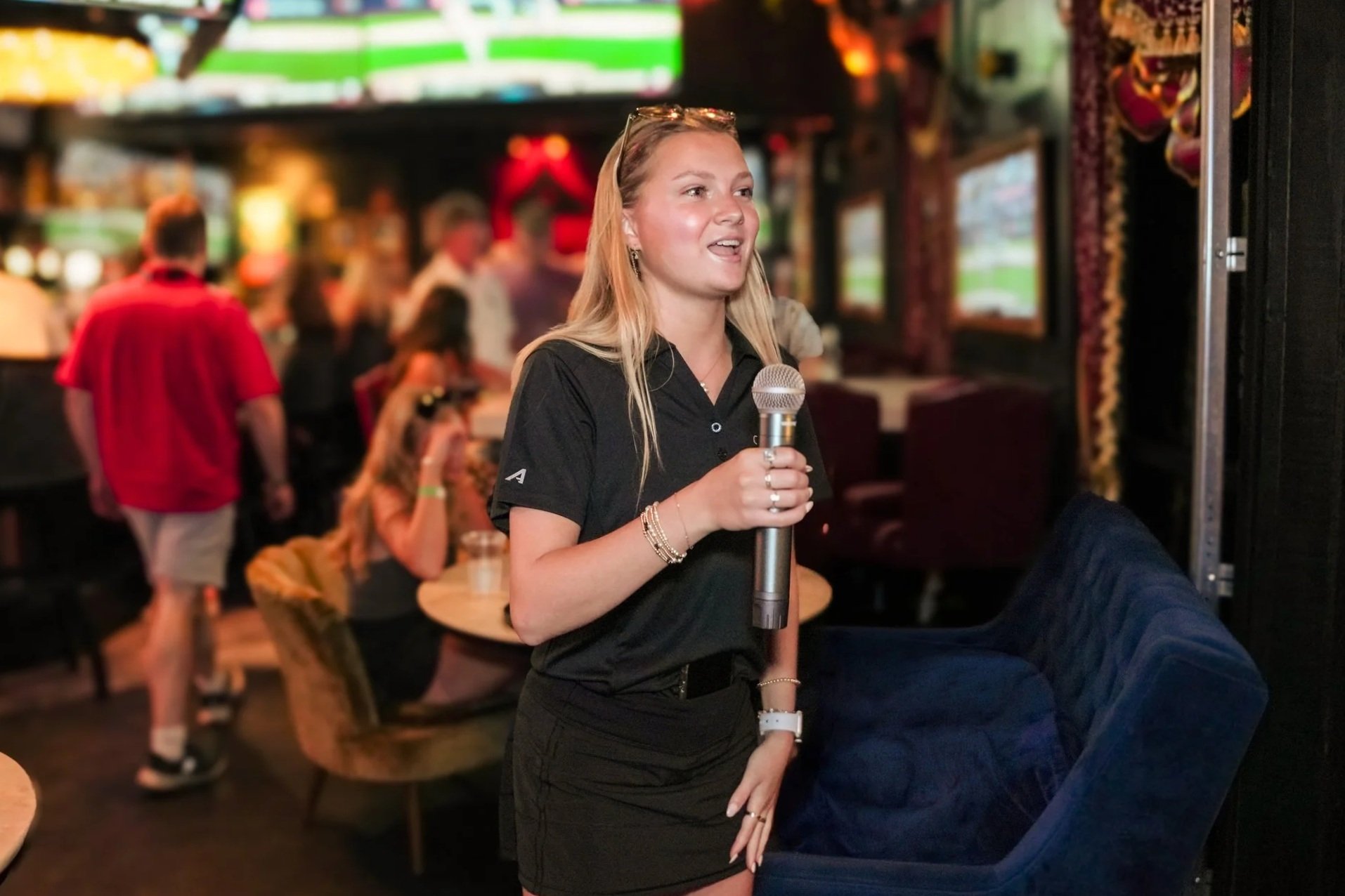 Oxford Marketing Co. social media manager Emily Stachowski announcing raffle winners at The Velvet Ditch Seafood & Sports Bar.