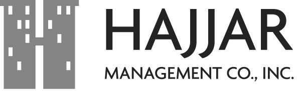 Logo of Hajar Management Co., Inc., featuring a stylized gray building with window-like details.