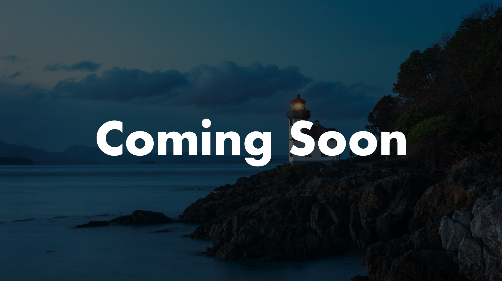 Nighttime scene of a lighthouse on a rocky shoreline with trees, calm water, and a cloudy sky, overlaid with the text 'Coming Soon'.