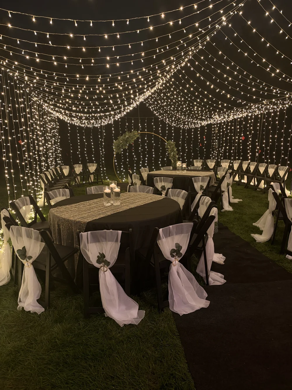 Glowing canopy and floral ceremony arch at the vow renewal