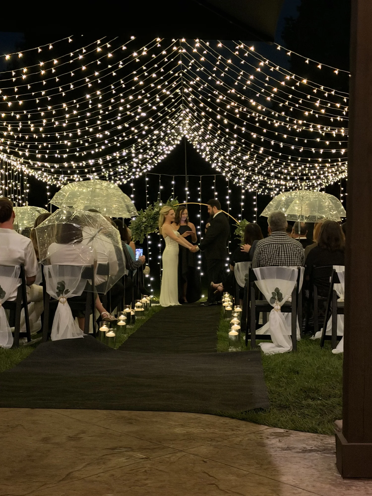 Mary Ann and Paco at the end of the illuminated ceremony aisle