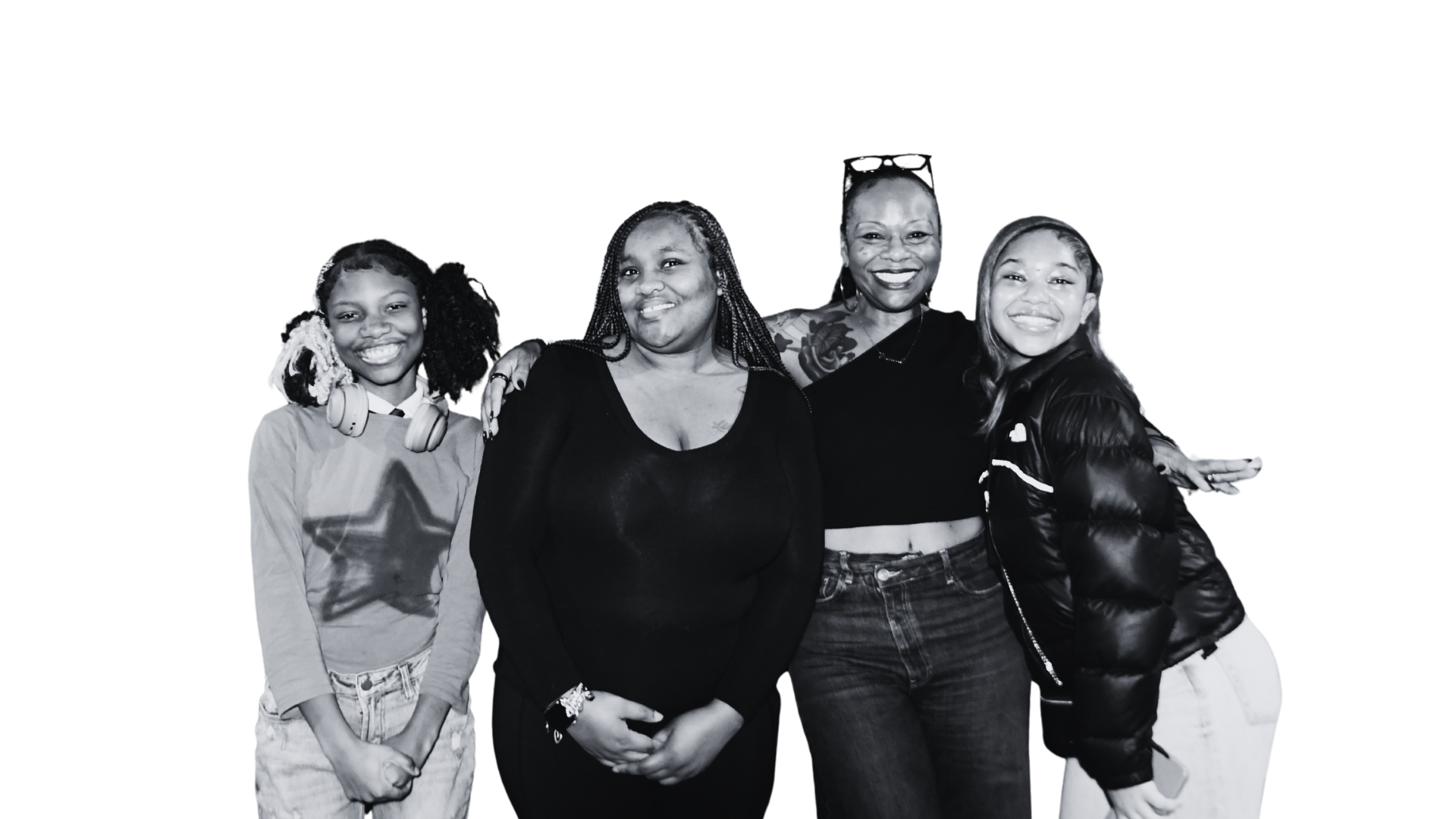 Group of four women and one girl smiling, some with arms around each other, wearing casual clothing, black and white photo.