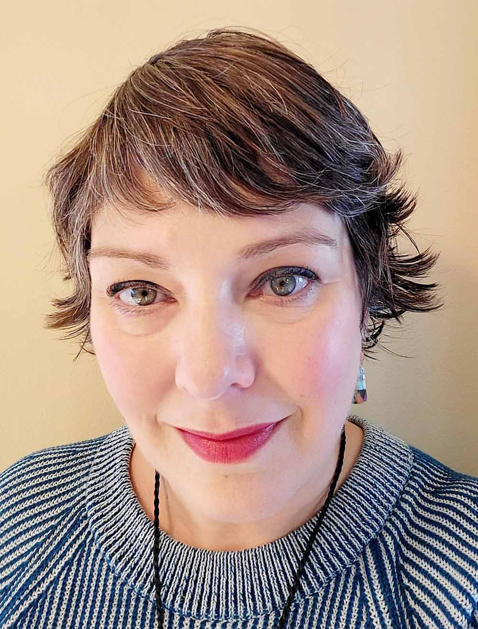 Picture is of a caucasian therapist with short wavy hair.