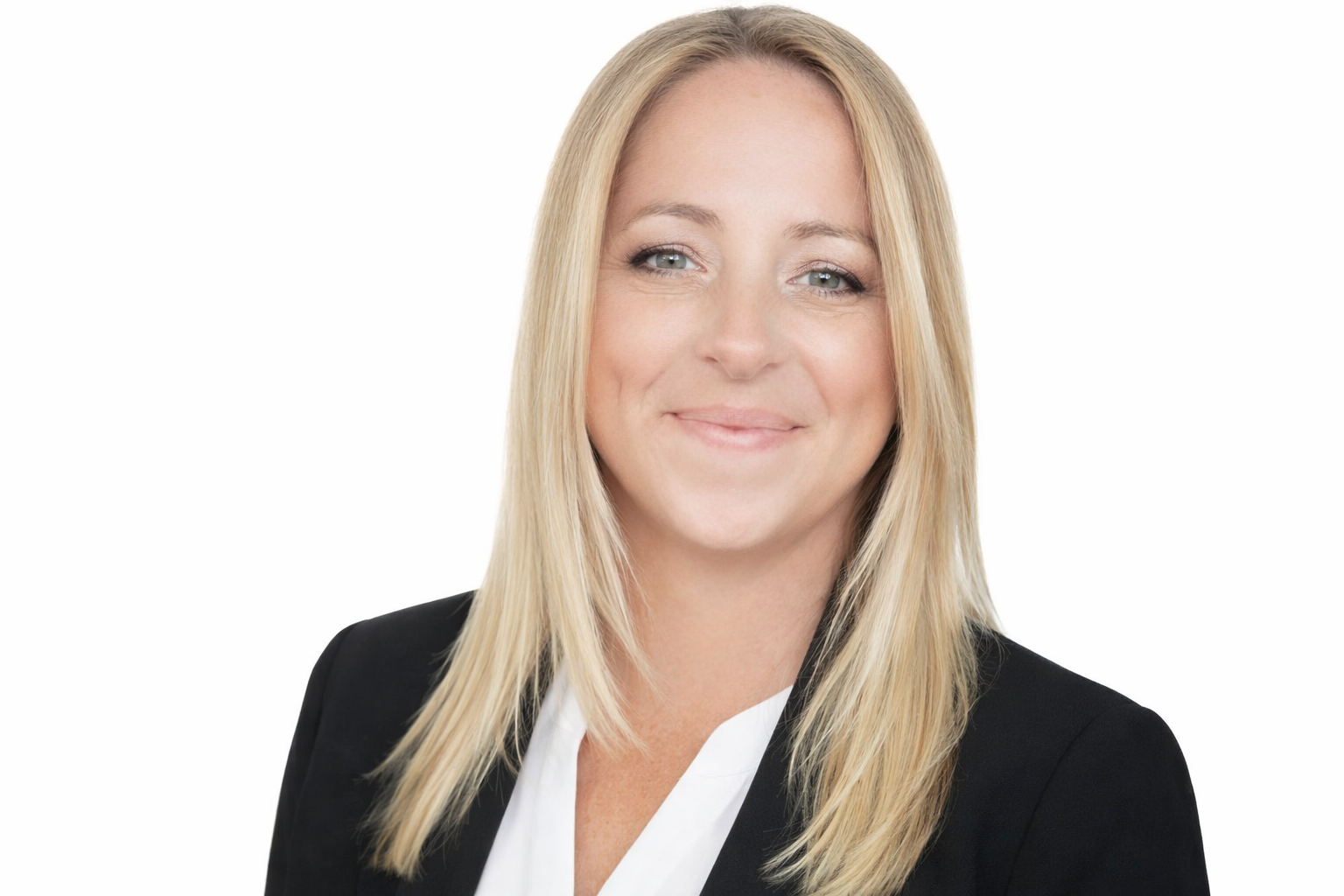 A professional woman with shoulder-length blonde hair, wearing a black blazer and white blouse, smiling against a plain white background.