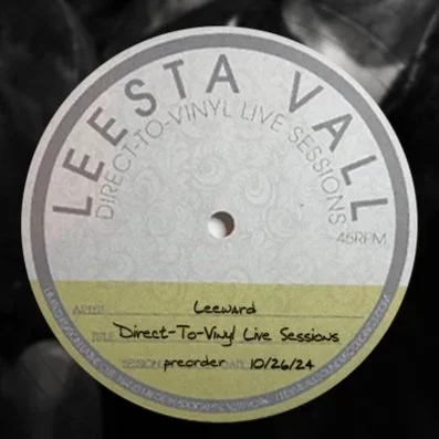 Close-up of a vinyl record label from Leesta Vall records with handwritten text indicating the artist name "Leeward," the event "Direct-To-Vinyl Live Sessions," and the preorder date "10/26/24."