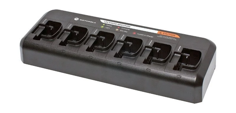 A battery charger with multiple slots for charging batteries, labeled with LED indicator lights and caution sign on top.