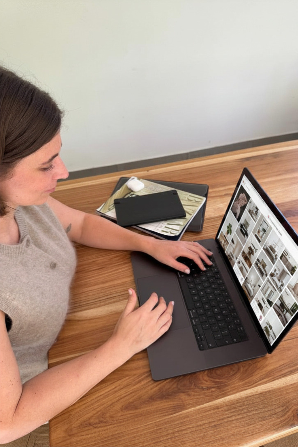 Interior designer using laptop to browse furniture inspiration and design ideas