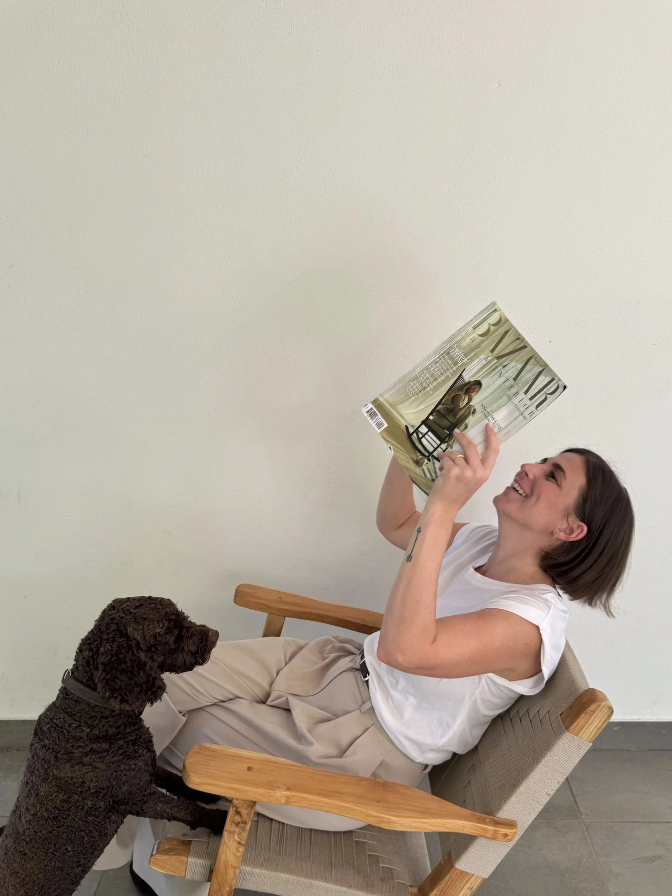 Interior designer with dogs reviewing design inspiration at home