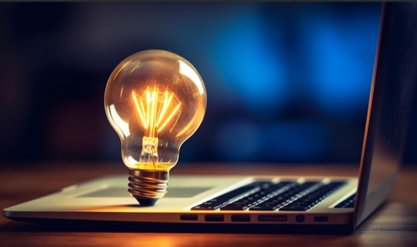 Laptop displaying a light bulb, representing ideas and practical resources for wound care consulting.