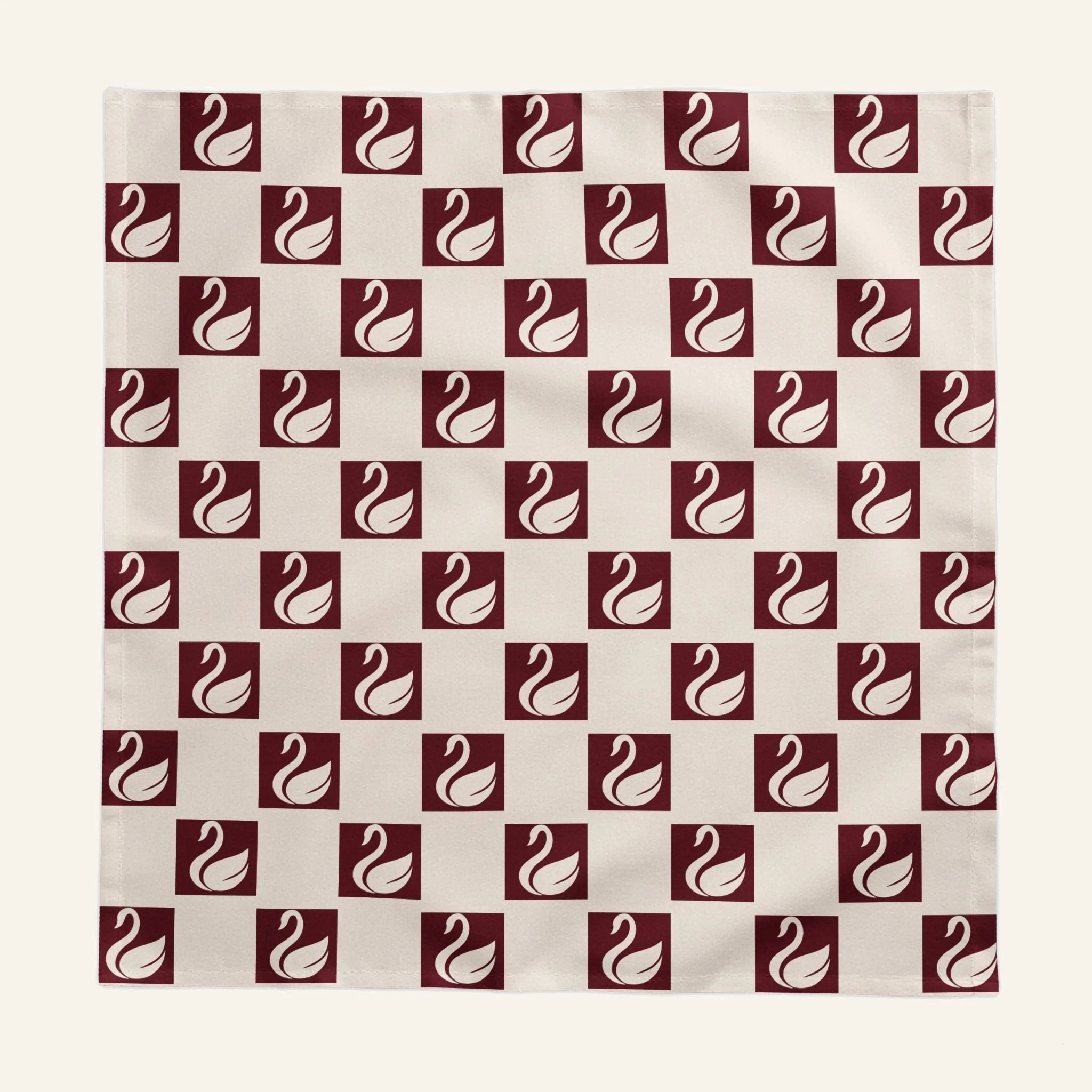 Close-up of oxblood and ivory swan geometric pattern on cotton tablecloth
