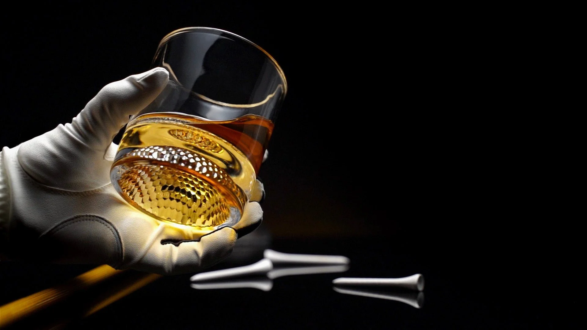 Close-up of golf ball whiskey glasses on a wooden surface