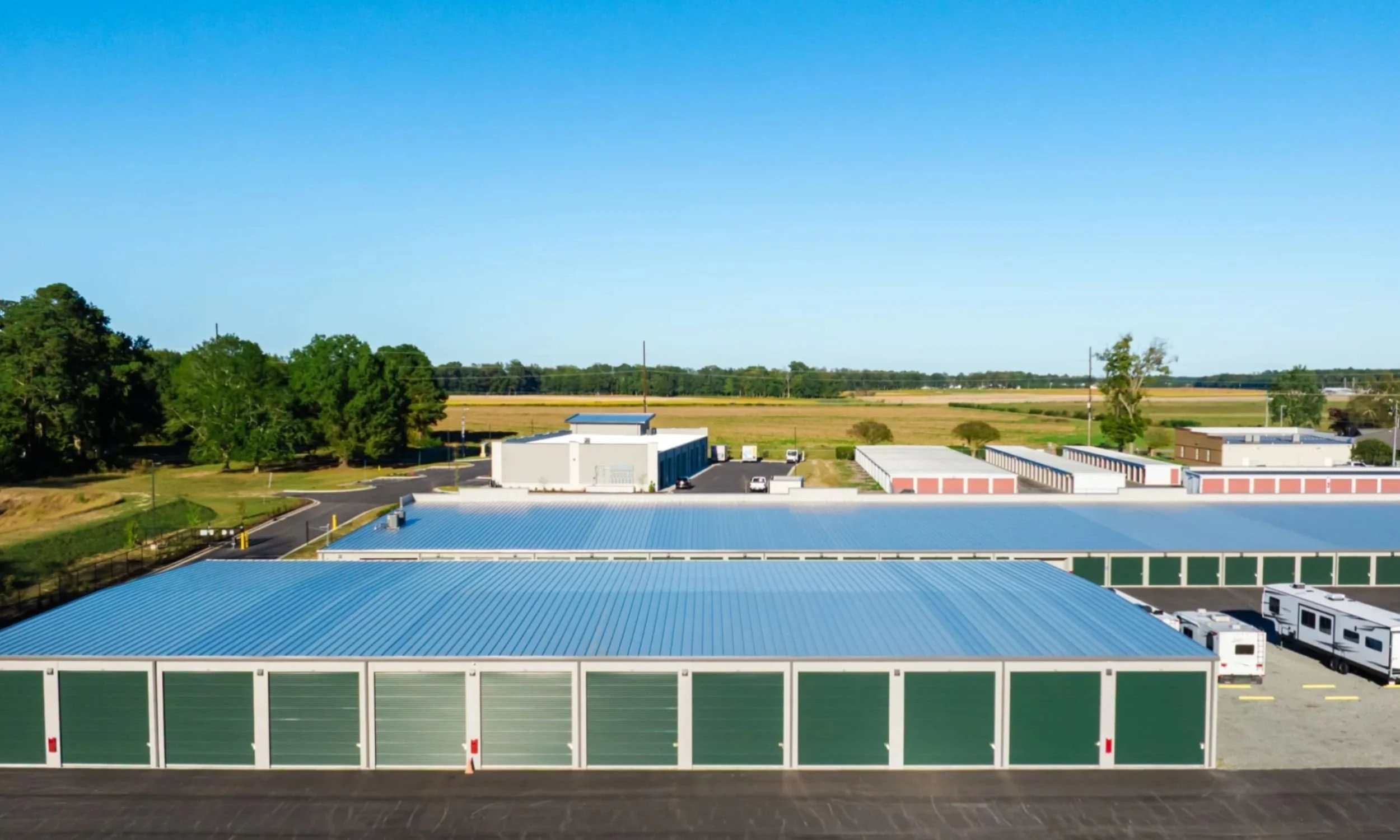 Aerial view of Storage Works in Wilmington NC designed by LAT34 Architecture with drive-up storage units, metal buildings, and efficient site circulation.