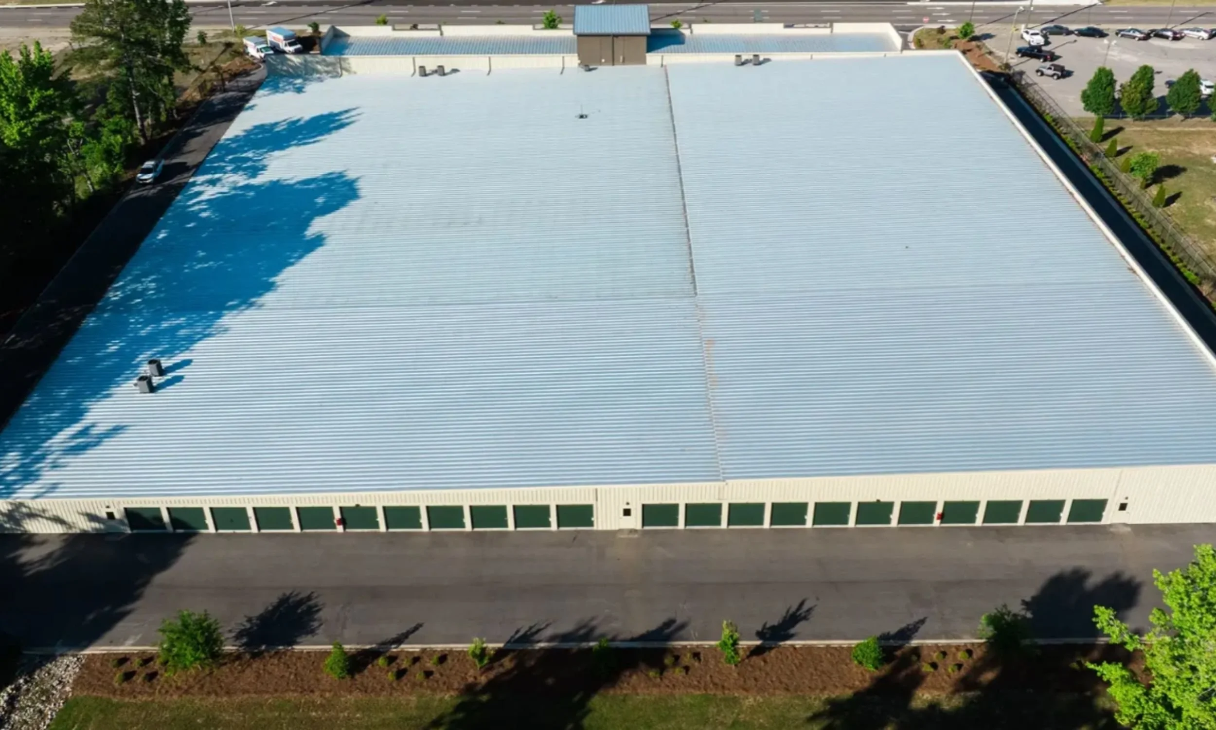 Large commercial storage facility in Wilmington NC designed by LAT34 Architecture with office frontage, metal building construction, and drive-up units.