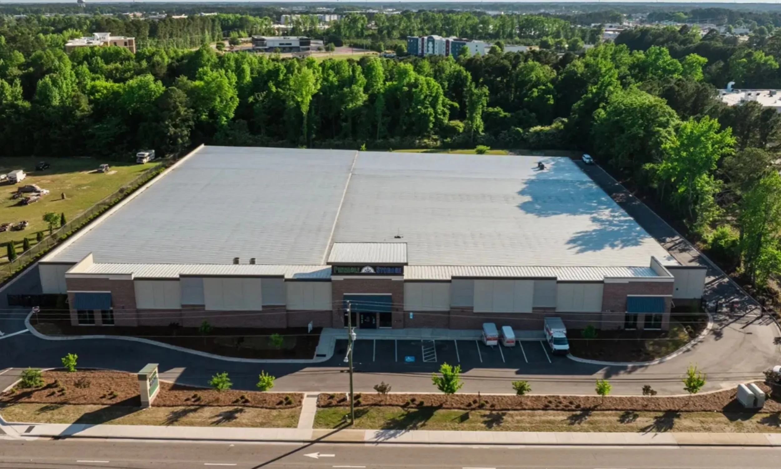 Overhead view of Pinnacle Commercial Project in Wilmington NC by LAT34 Architecture with metal roofing, storage units, and efficient site circulation.