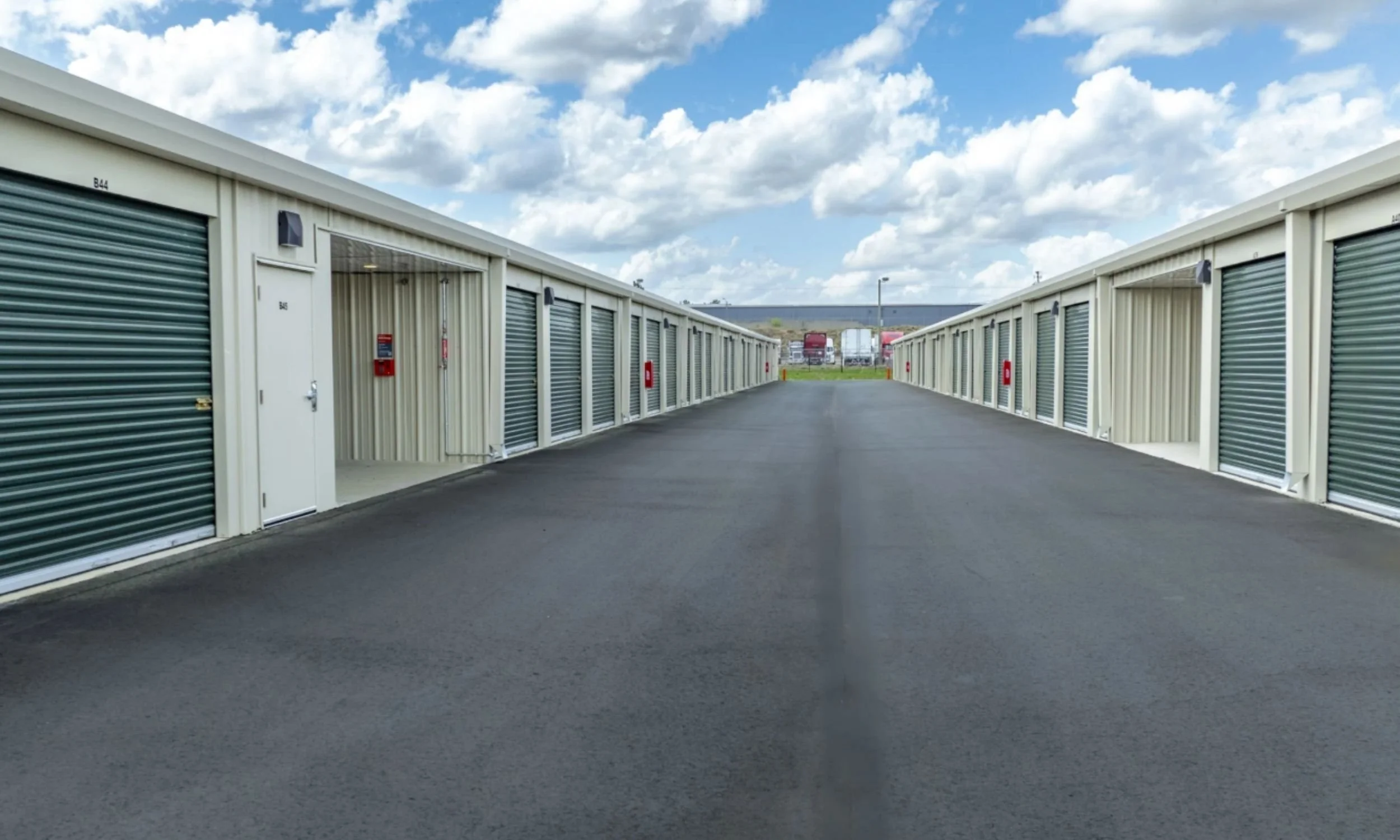 Drive-up storage units at Public Storage facility designed by LAT34 Architecture with roll-up doors and paved access lanes.