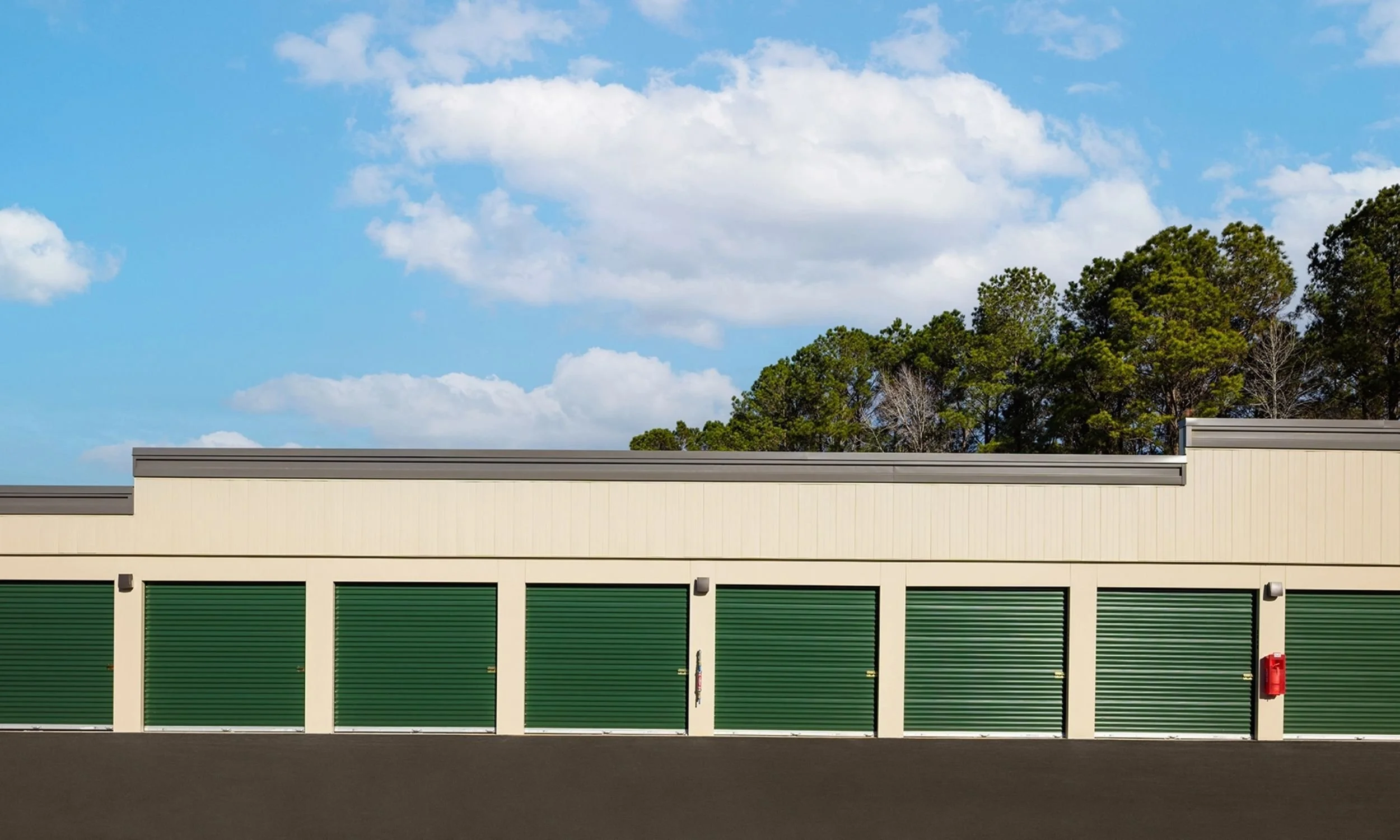 Drive-up storage units at Pinnacle Self-Storage Campus designed by LAT34 Architecture with roll-up doors and accessible commercial storage layout.