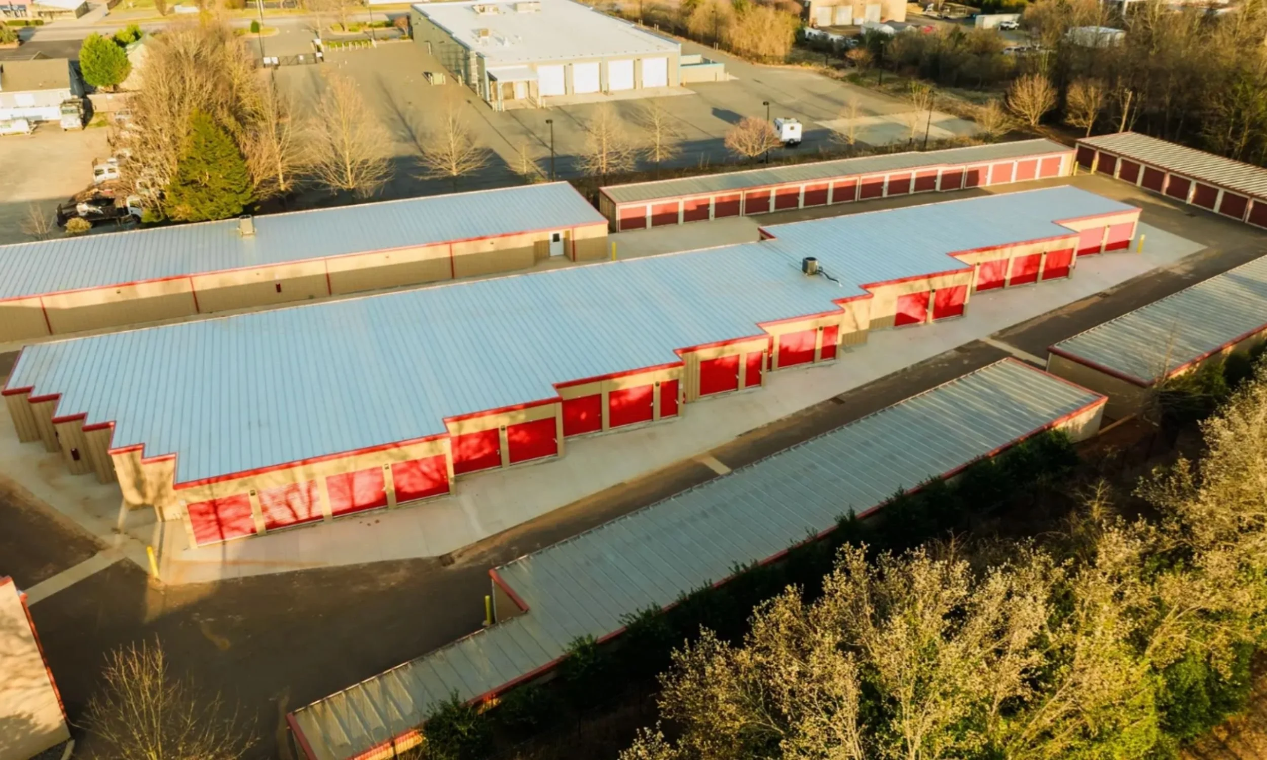 Wilmington NC self-storage facility designed by LAT34 Architecture with red roll-up doors, metal buildings, and drive-up storage access.