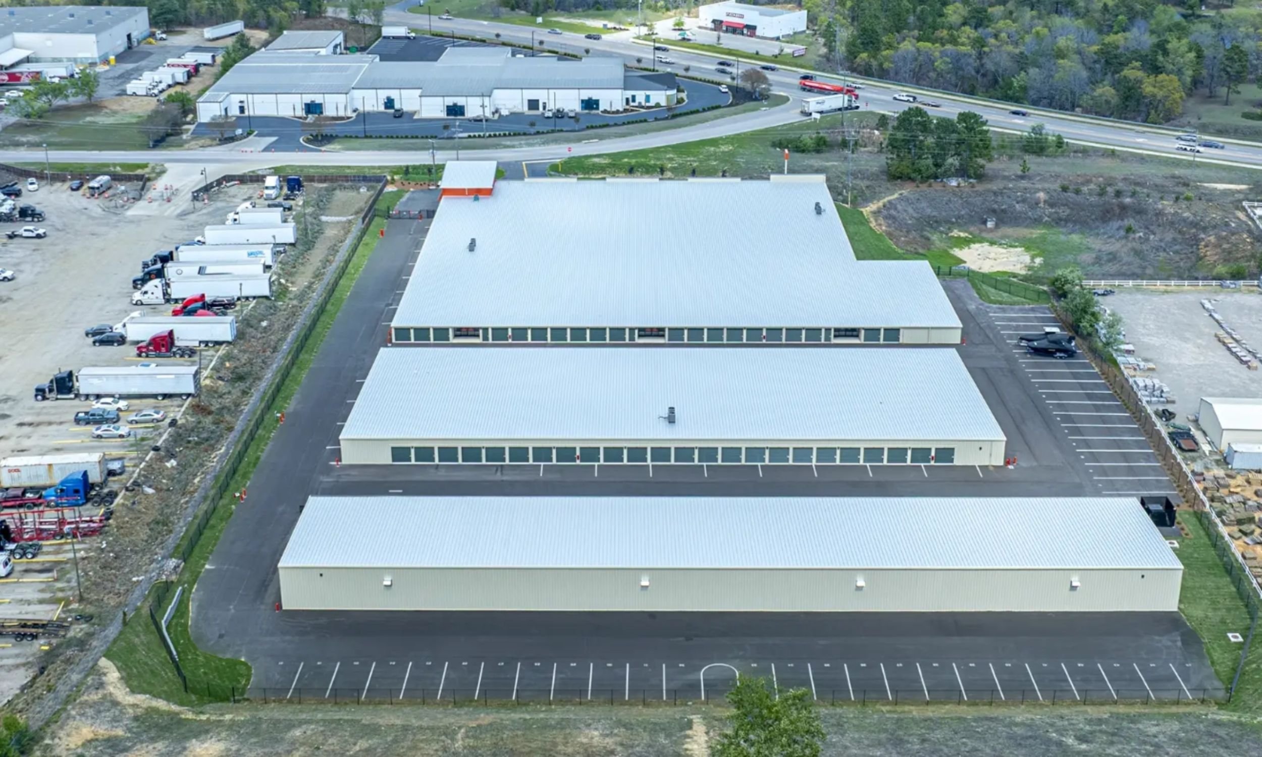 Large Public Storage commercial facility designed by LAT34 Architecture with multiple storage buildings, metal roofing, and organized site access.