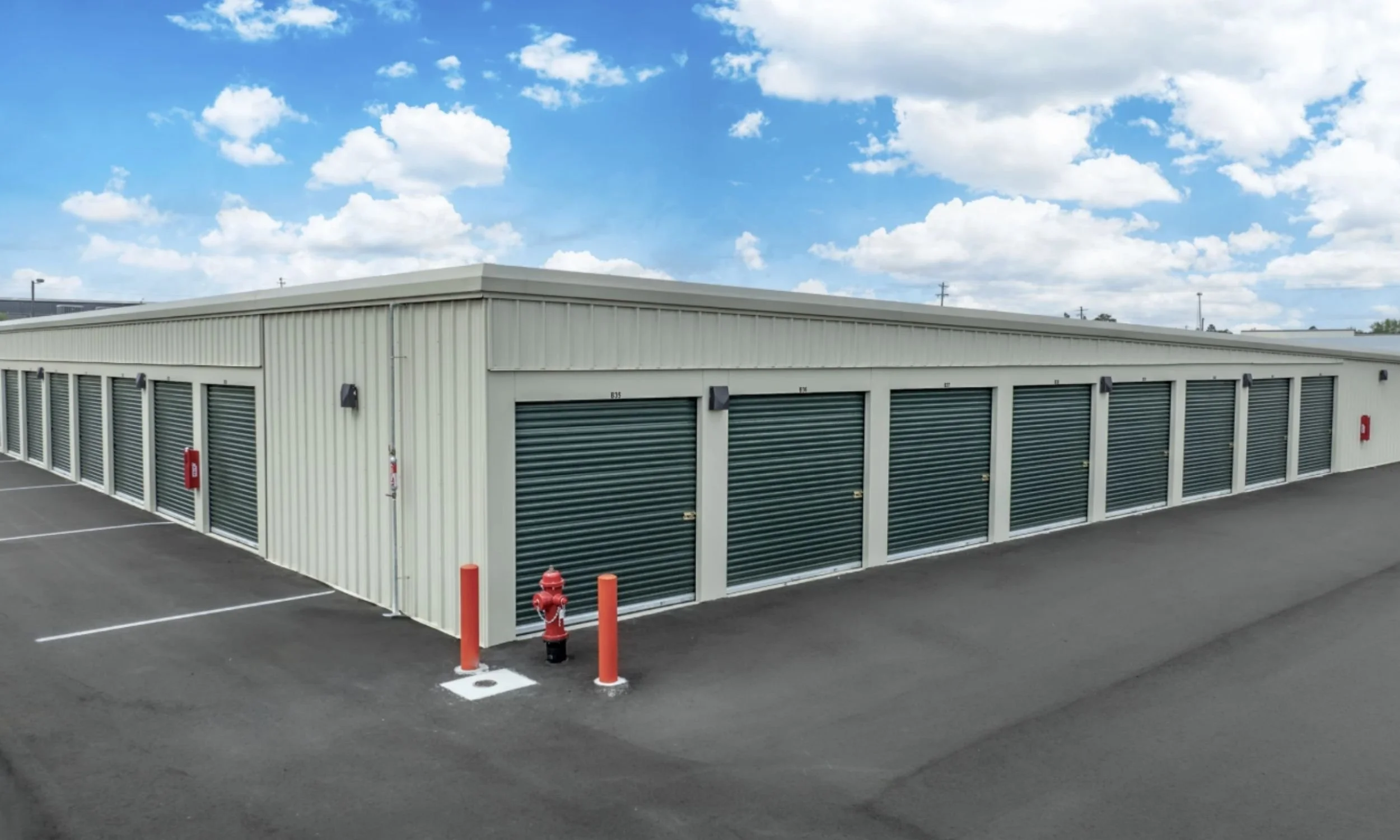 Public Storage commercial drive-up units designed by LAT34 Architecture with metal building exterior, roll-up doors, and paved storage access.