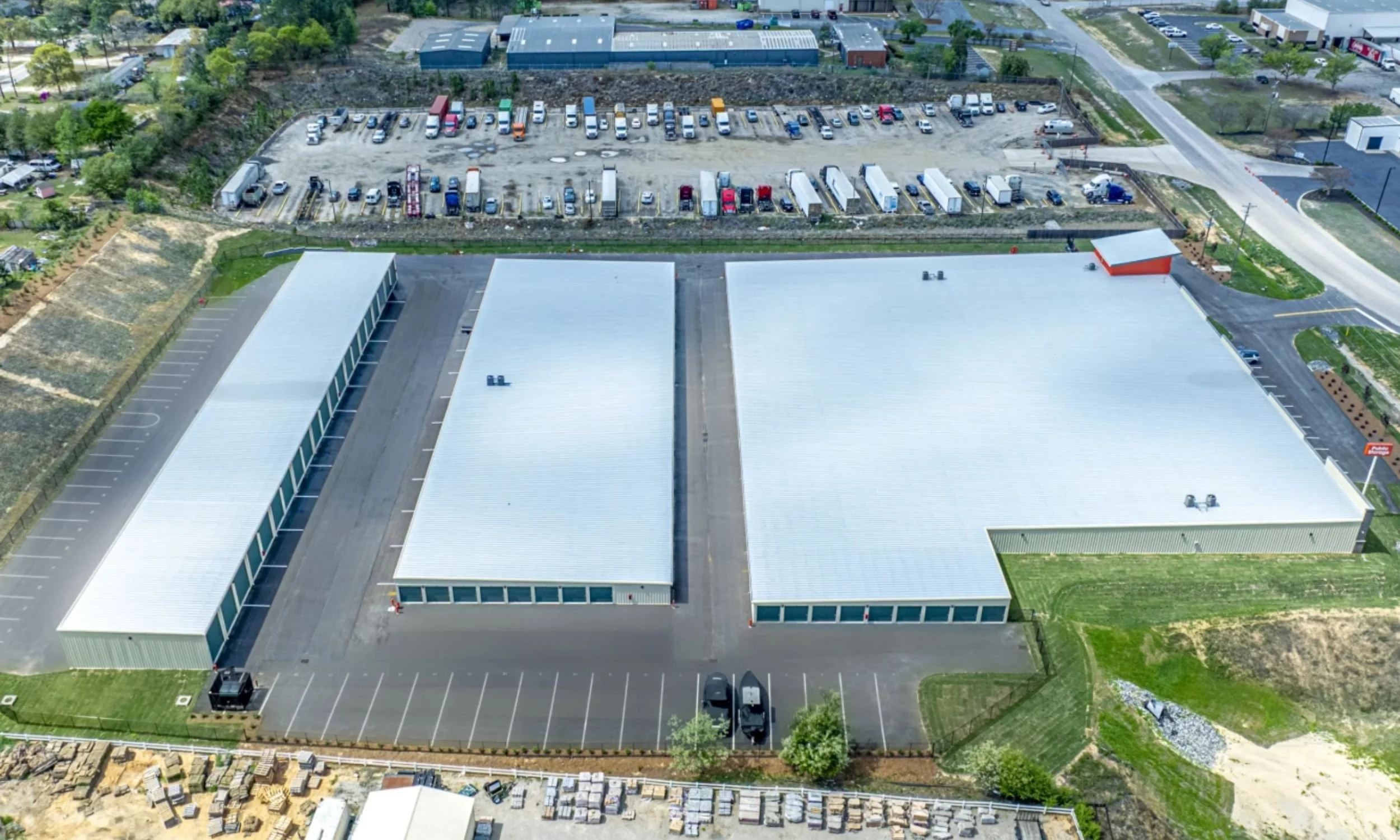 Commercial site planning view of a Public Storage self-storage facility by LAT34 Architecture showing multiple storage buildings and vehicle circulation.