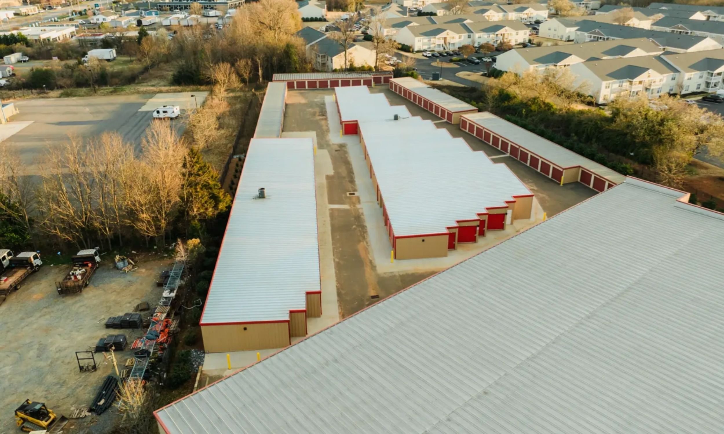 Aerial view of a commercial drive-up self-storage facility in Wilmington NC designed by LAT34 Architecture with multiple storage buildings and site circulation.