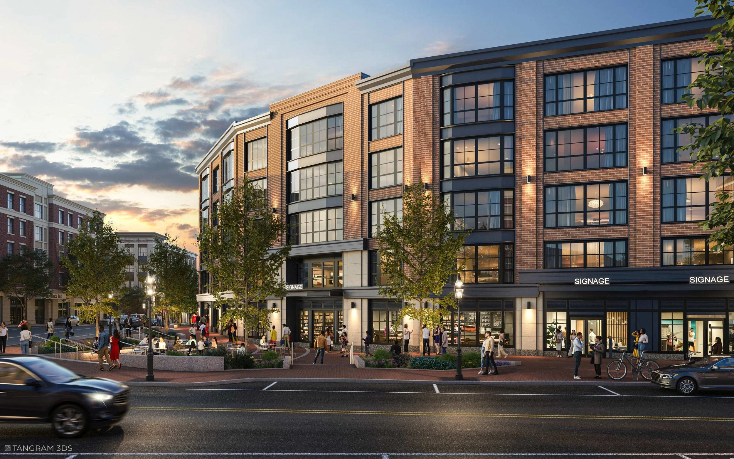 Modern multi-story brick building with large windows, storefront signage, and a busy sidewalk with people walking, trees, and streetlights at dusk.