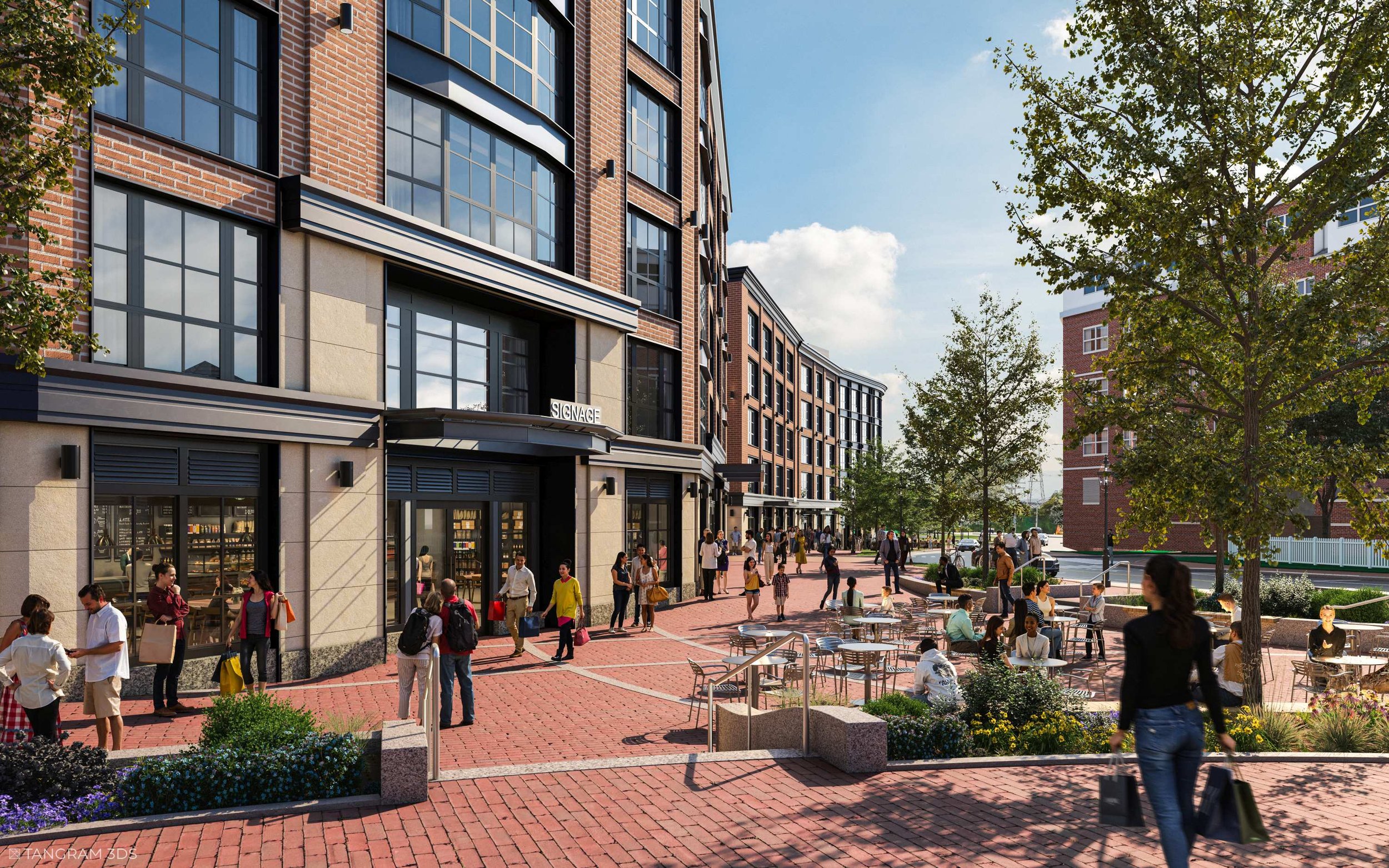 A busy urban street scene with people walking and gathering outside modern brick and glass buildings, with trees and outdoor seating on a clear sunny day.
