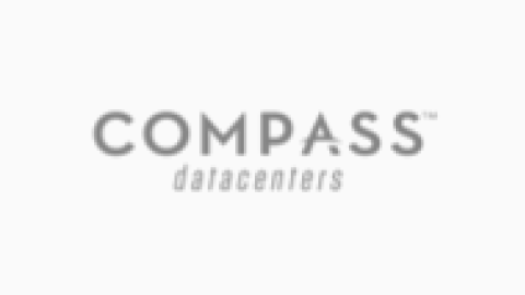 The logo of COMPASS Data Centers in gray on a white background.