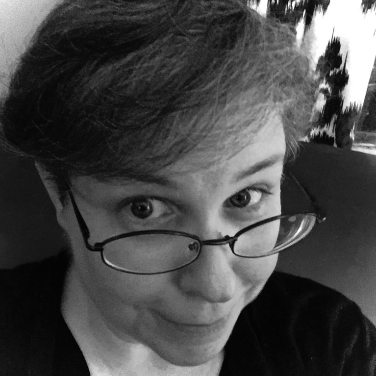 A close-up black and white photo of Bailey G. Albreit, a person with short hair, wearing glasses, smiling slightly, with background trees.