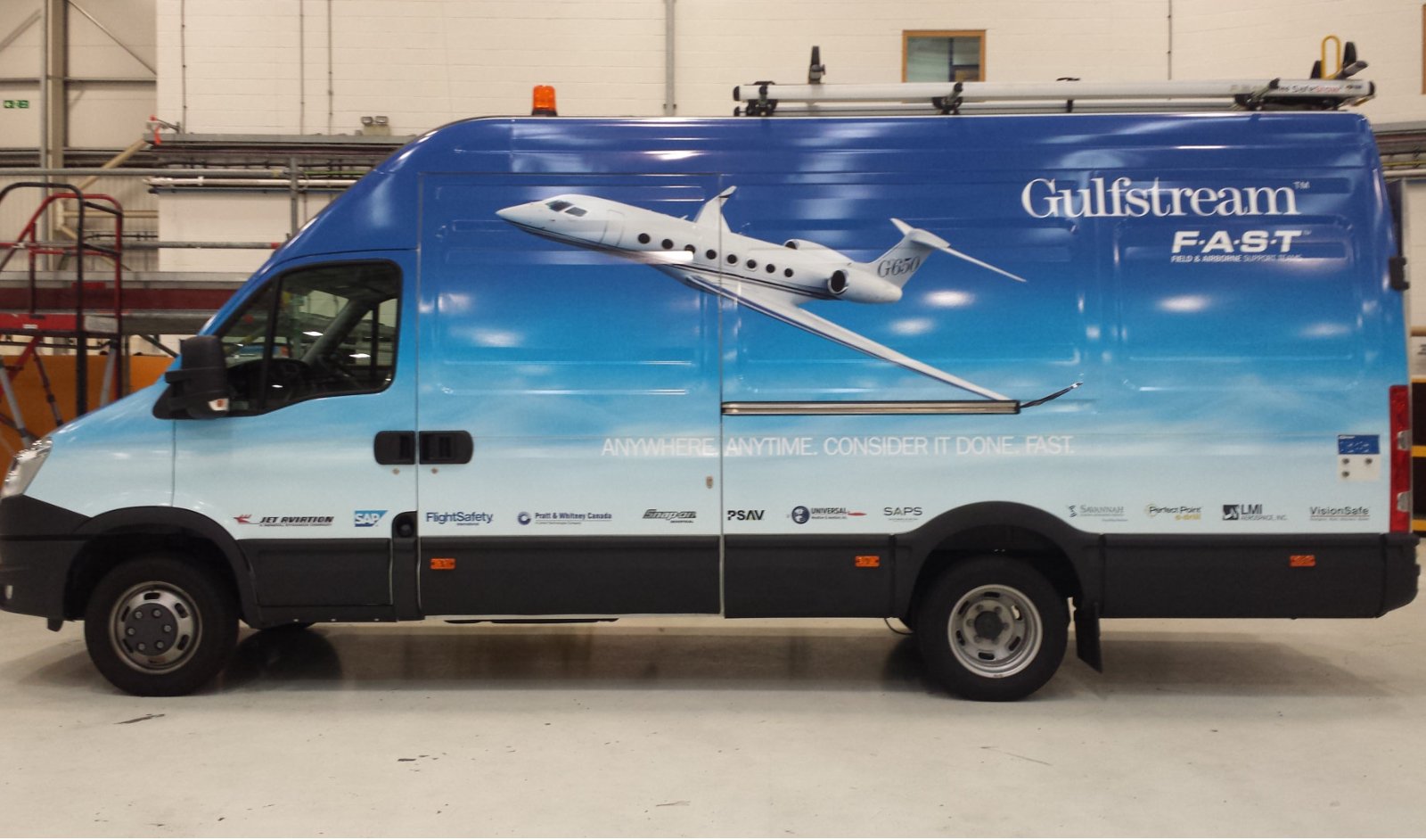 Delivery van with Gulfstream branding, featuring an image of a Gulfstream aircraft and various sponsor logos.