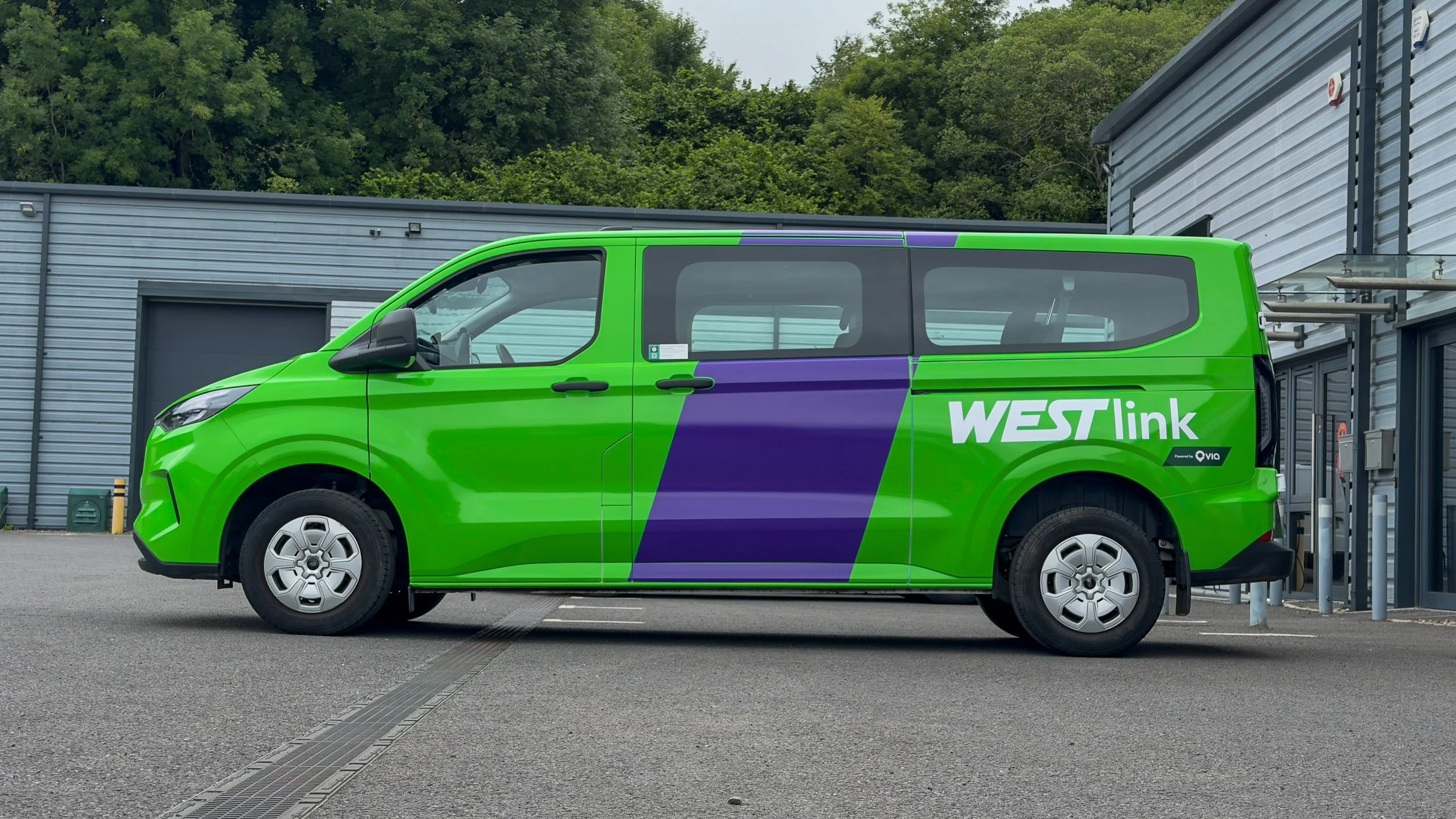 West-link Bus full fleet vehicle wrap with striking bold graphics parked outside of zest graphics installation centre