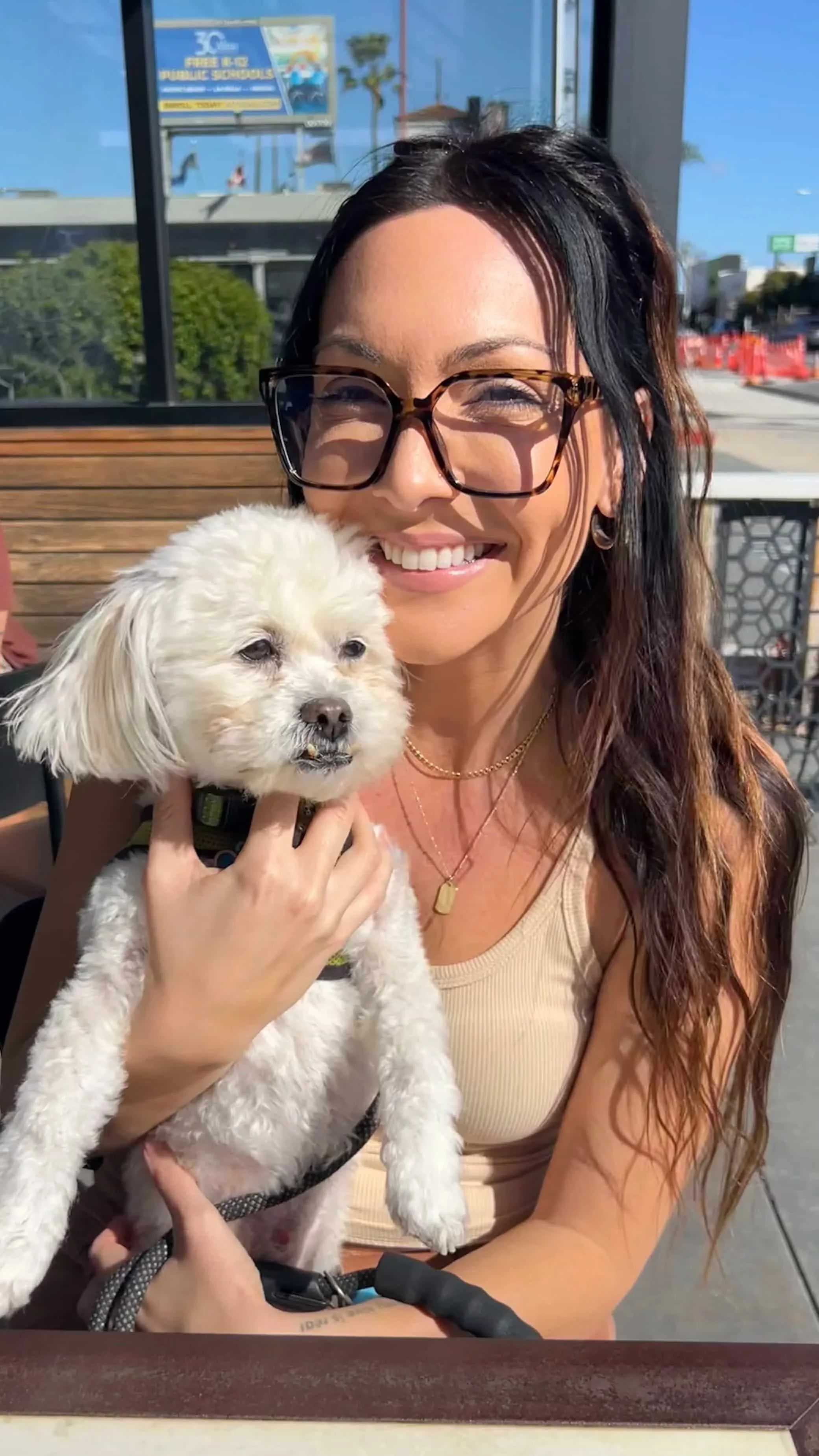 Lauren Nina, Denver trauma therapist for women, holding her dog in a relaxed, welcoming setting
