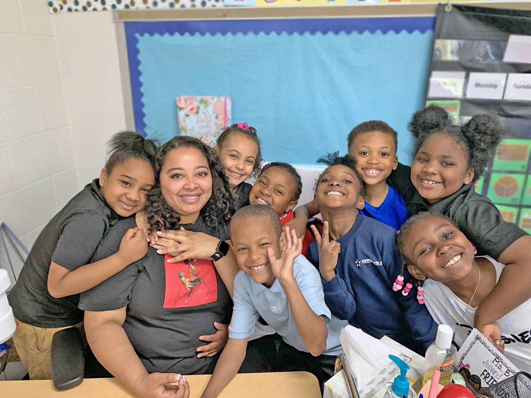 Group of students and teacher smiling.