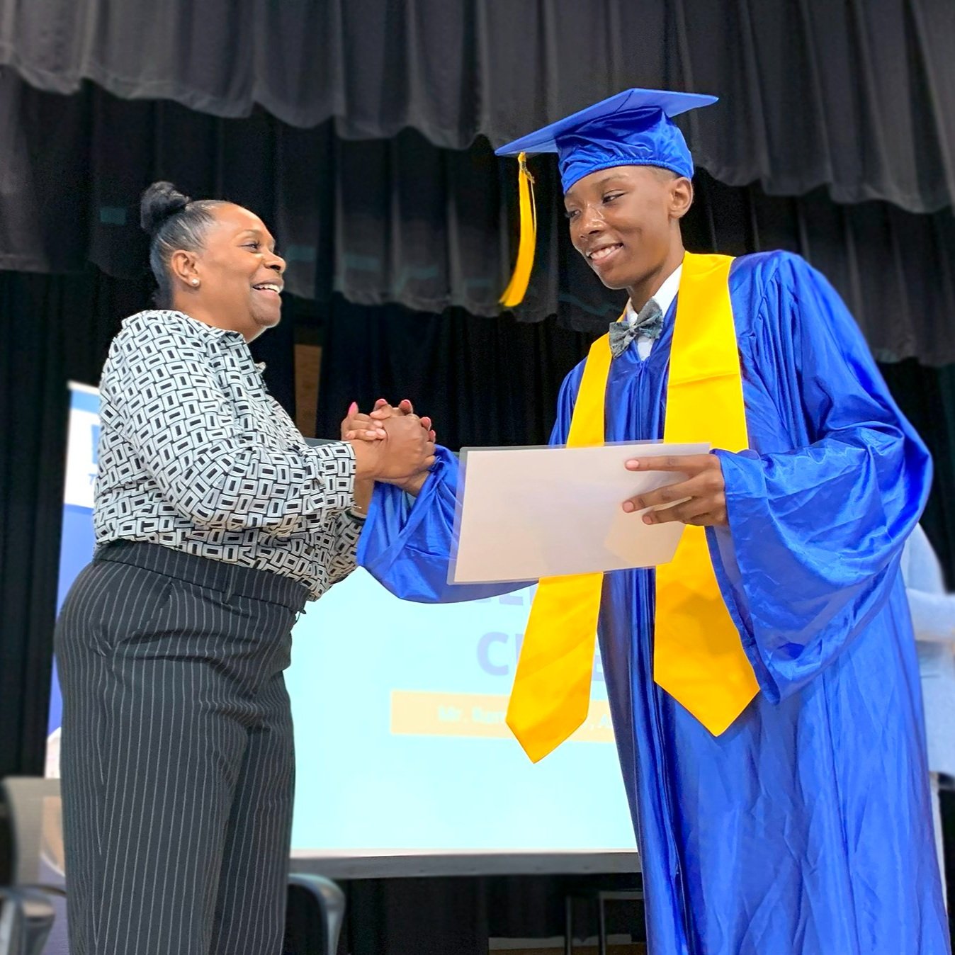 Our CEO, Dr. Shana Ford, congratulating a Grade 8 graduate.