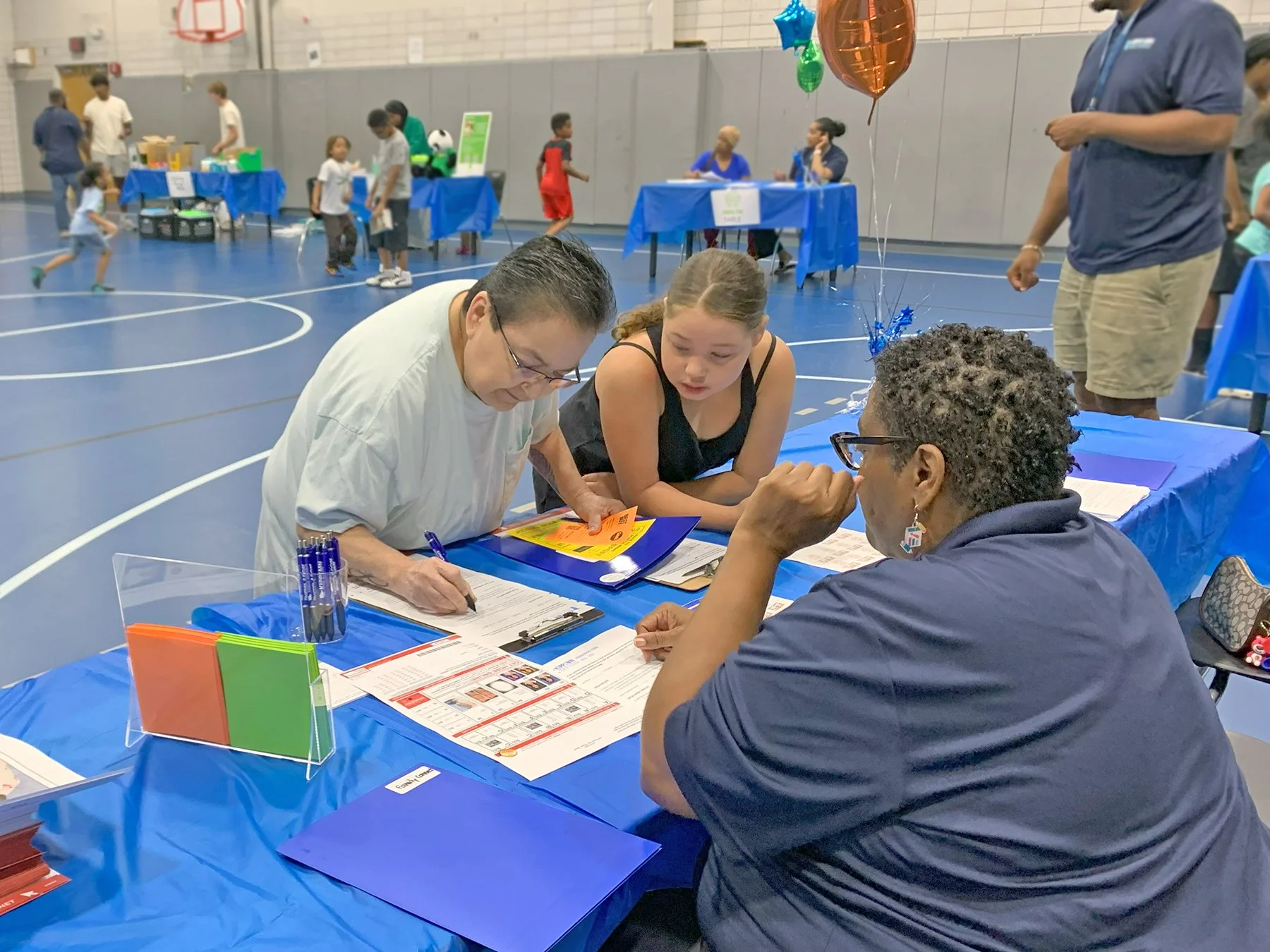 Parent and student completing forms at Back to School Night.