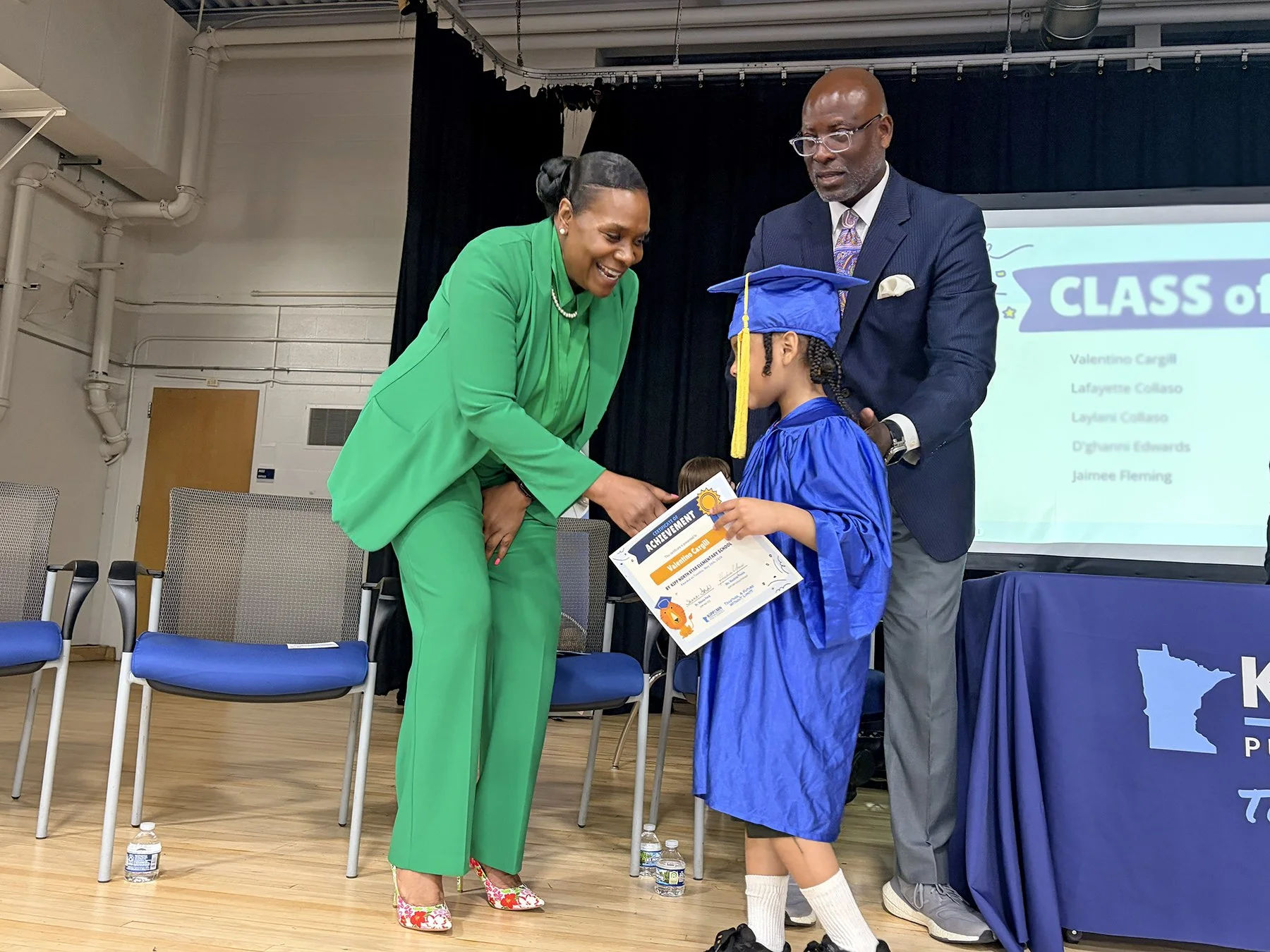 Our CEO, Dr. Shana Ford congratulating a Kindergarten graduate.