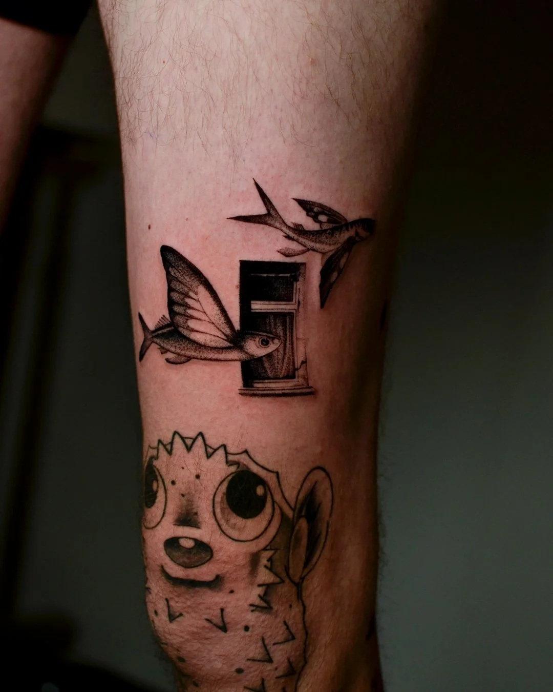 Tattoo of two hummingbirds flying near a vintage radio on a person's arm.
