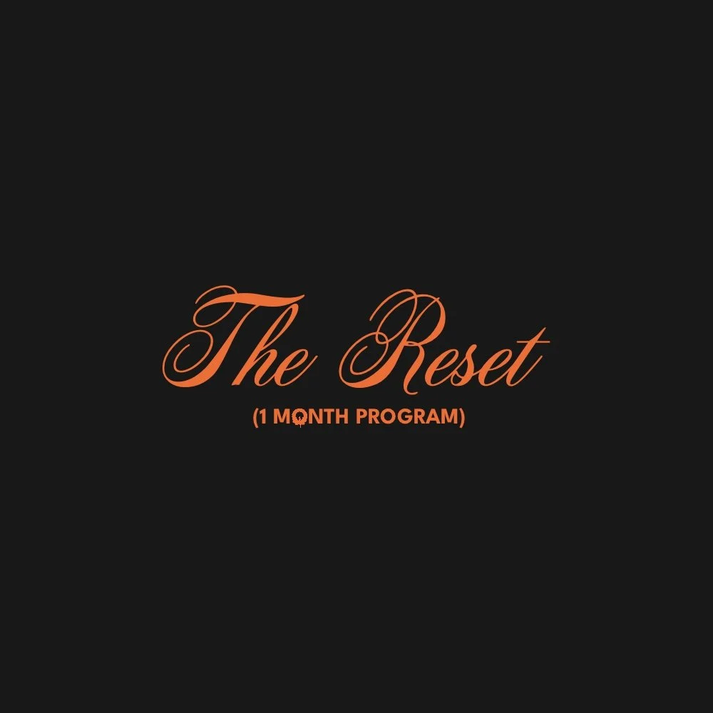 Text reading "The Reset (1 Month Program)" on a black background with orange cursive font.