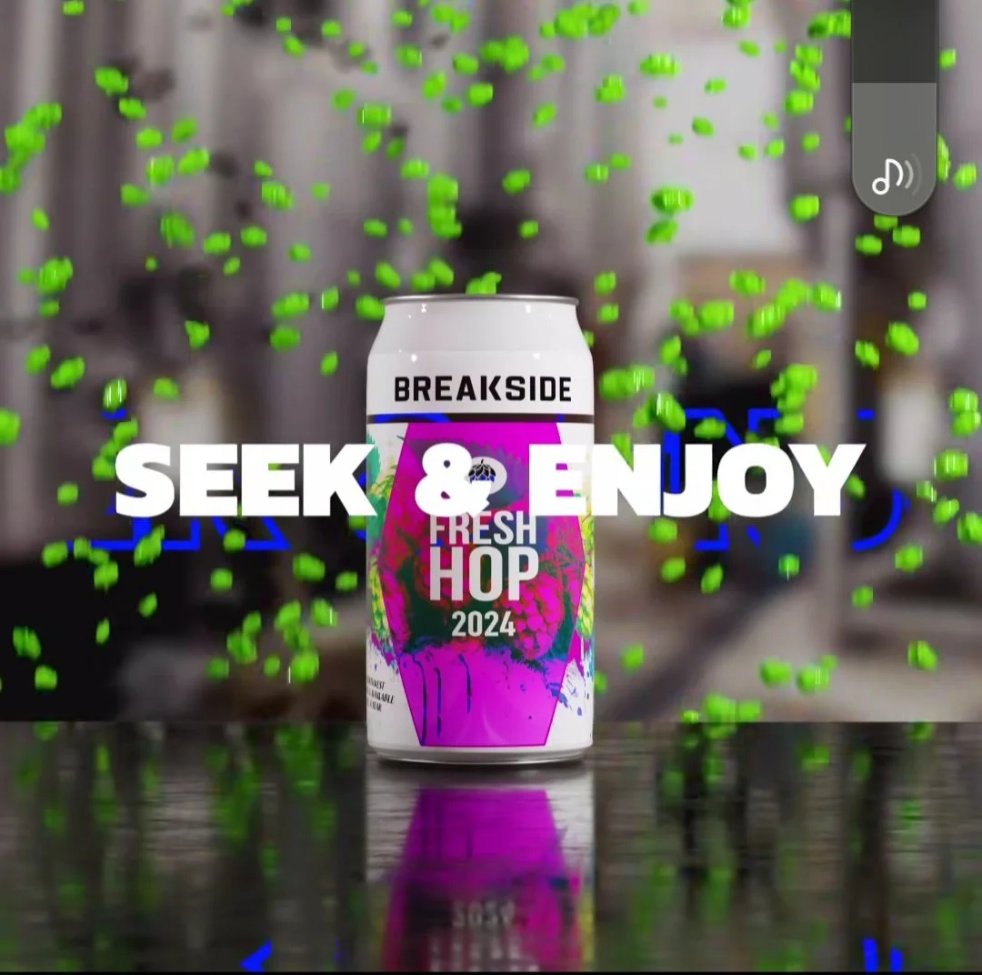 Breakside Fresh Hop 2024 beer can with text "Seek & Enjoy," surrounded by floating green particles.